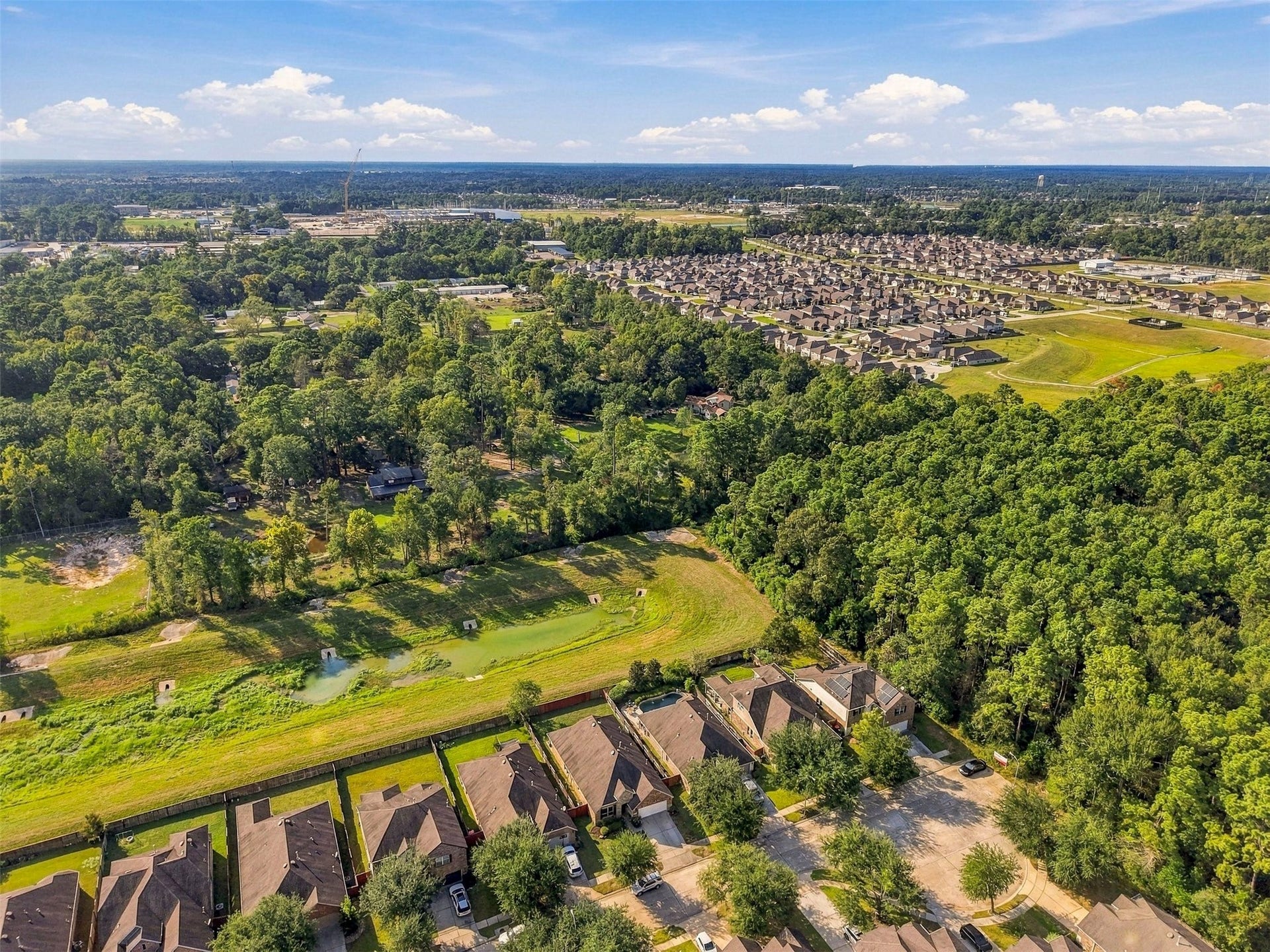 4557 Argonne Woods Drive, Porter, TX 77365 Charming neighborhood featuring spacious homes nestled alongside lush green spaces and scenic views, perfect for enjoying nature while remaining close to community amenities.