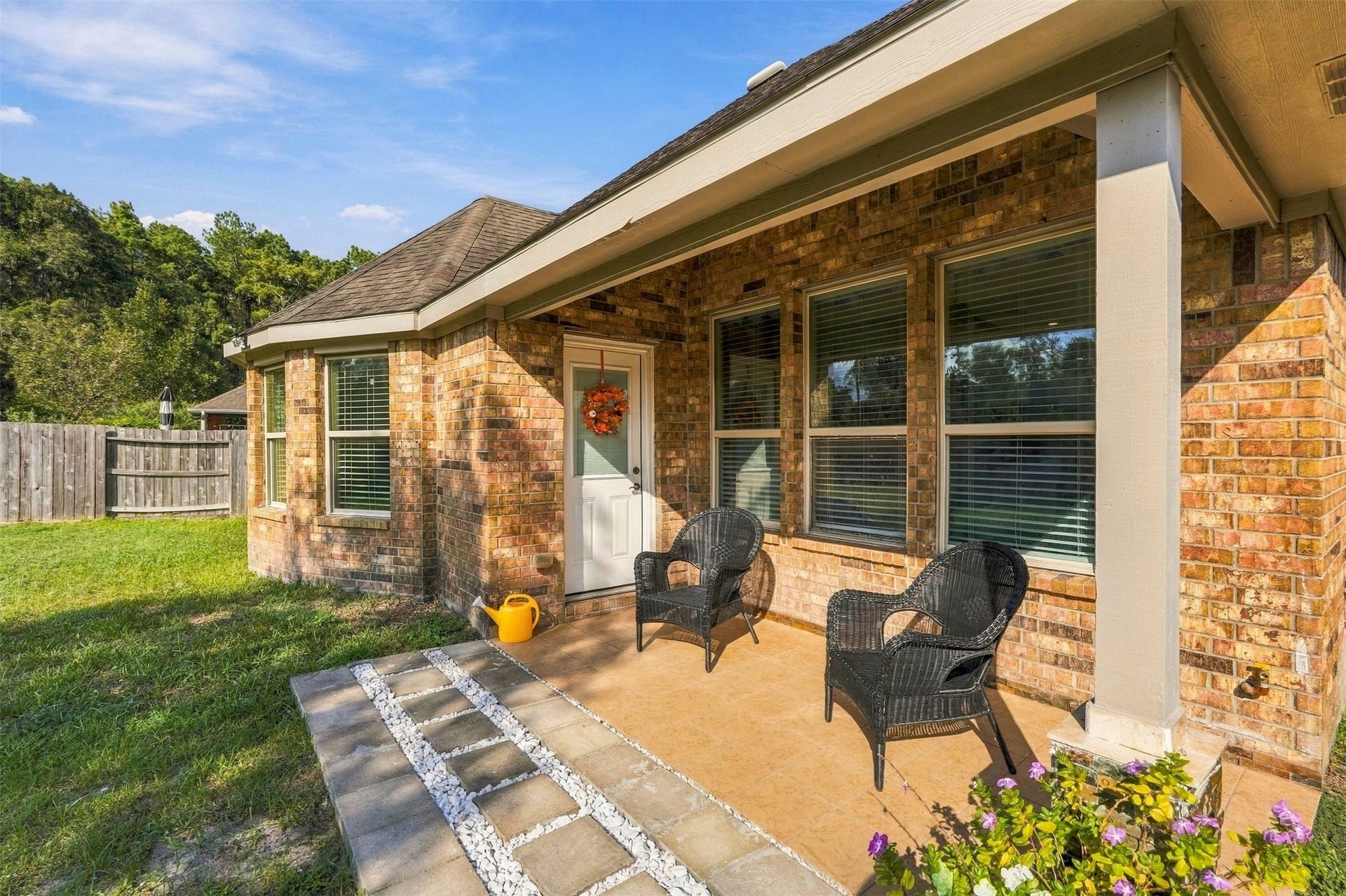 4557 Argonne Woods Drive, Porter, TX 77365 Charming brick patio with cozy seating, perfect for relaxing and enjoying the serene backyard views.