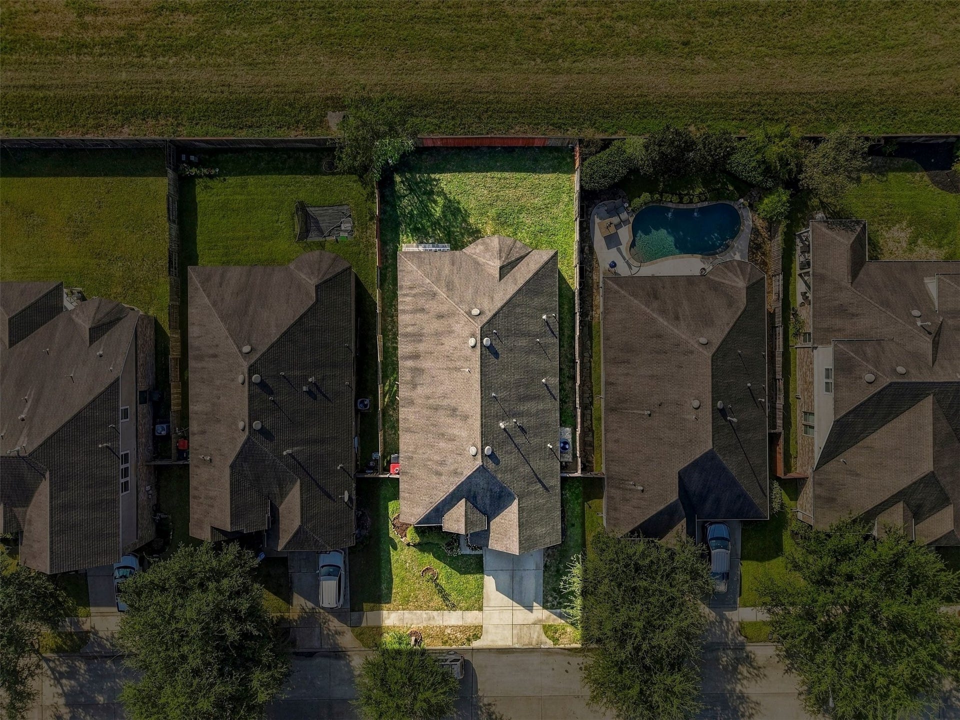 4557 Argonne Woods Drive, Porter, TX 77365 Charming suburban home with a spacious backyard, surrounded by well-maintained neighboring properties and lush greenery. Ideal for family living.