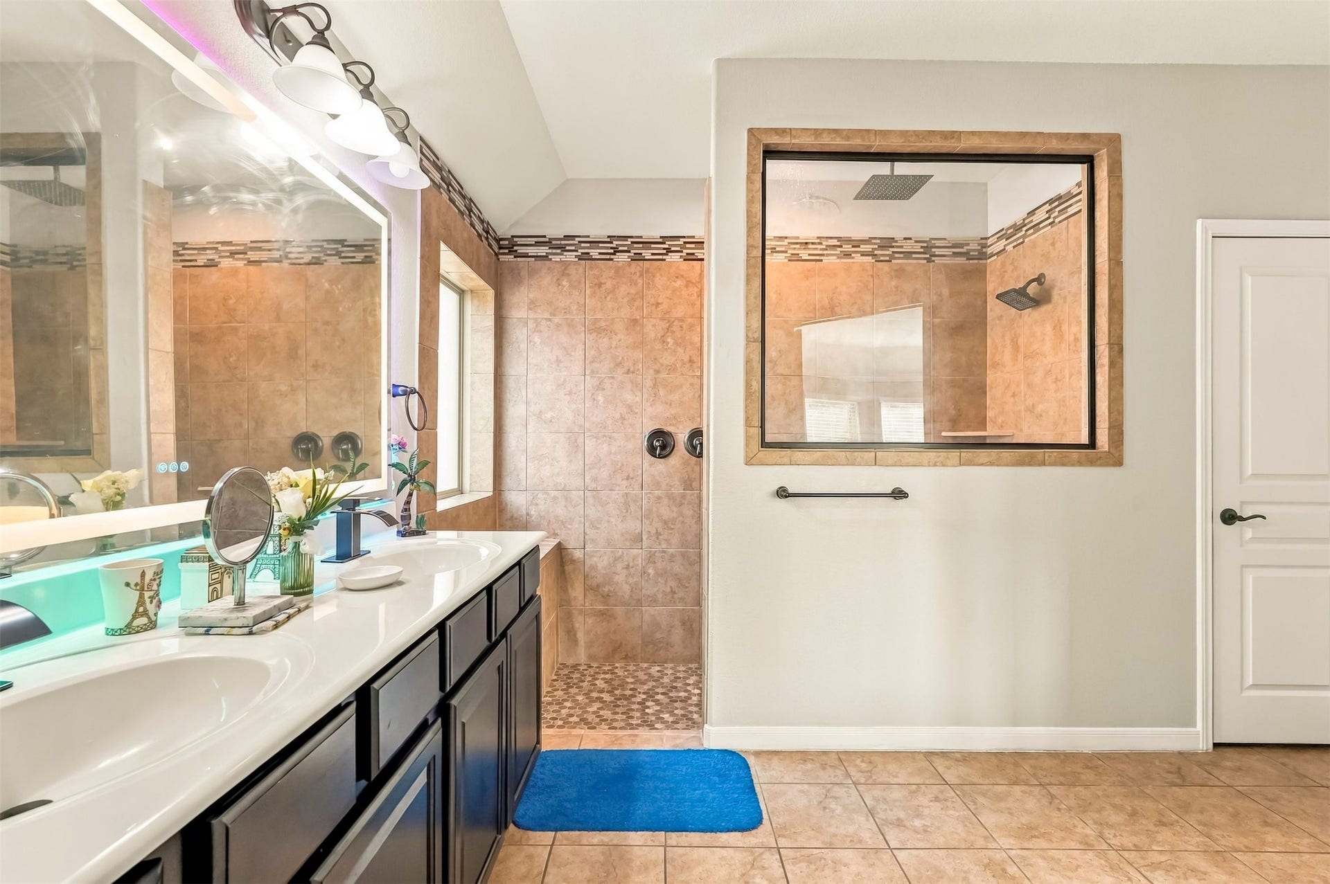 4557 Argonne Woods Drive, Porter, TX 77365 Spacious bathroom featuring a double vanity with sleek fixtures, and a large walk-in shower with elegant tile work.