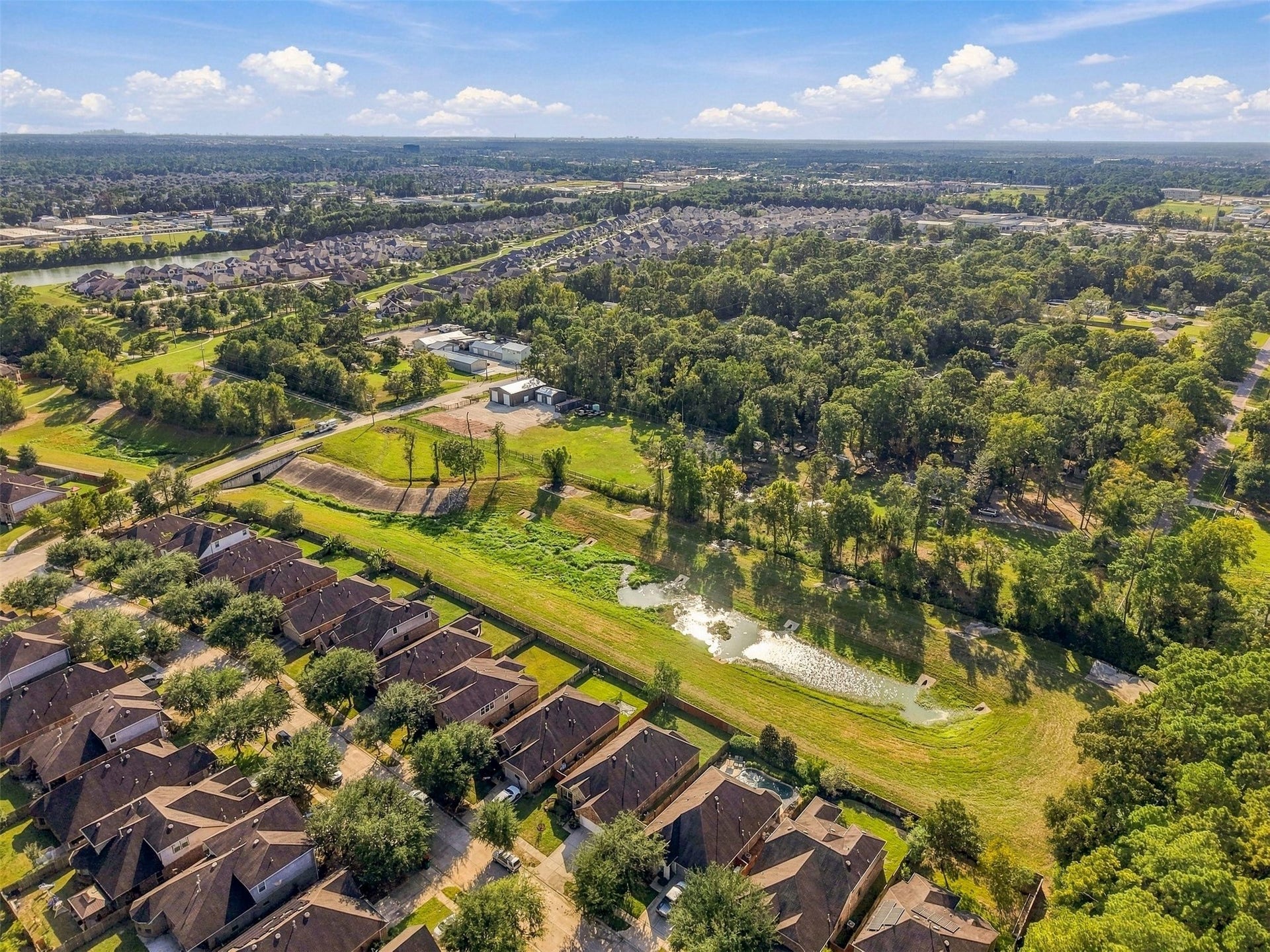 4557 Argonne Woods Drive, Porter, TX 77365 Nestled in a serene neighborhood, this property offers picturesque views of lush greenery and a tranquil water feature, perfect for nature lovers seeking a peaceful retreat.