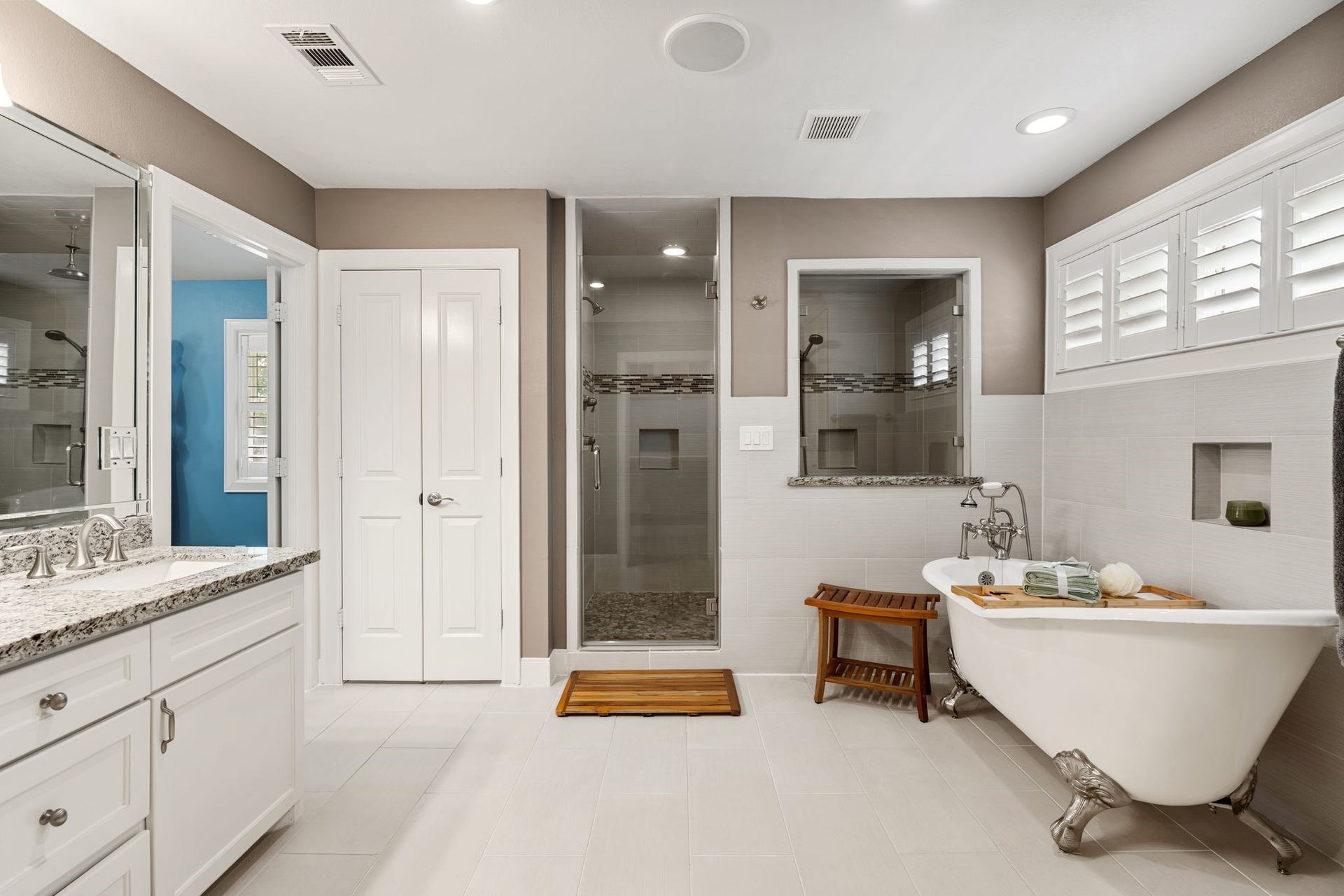 11519 Lakeside Place Drive, Houston, TX 77077 Elegant bathroom featuring a spacious walk-in shower, classic clawfoot tub, dual vanity with granite countertops, and ample natural light.