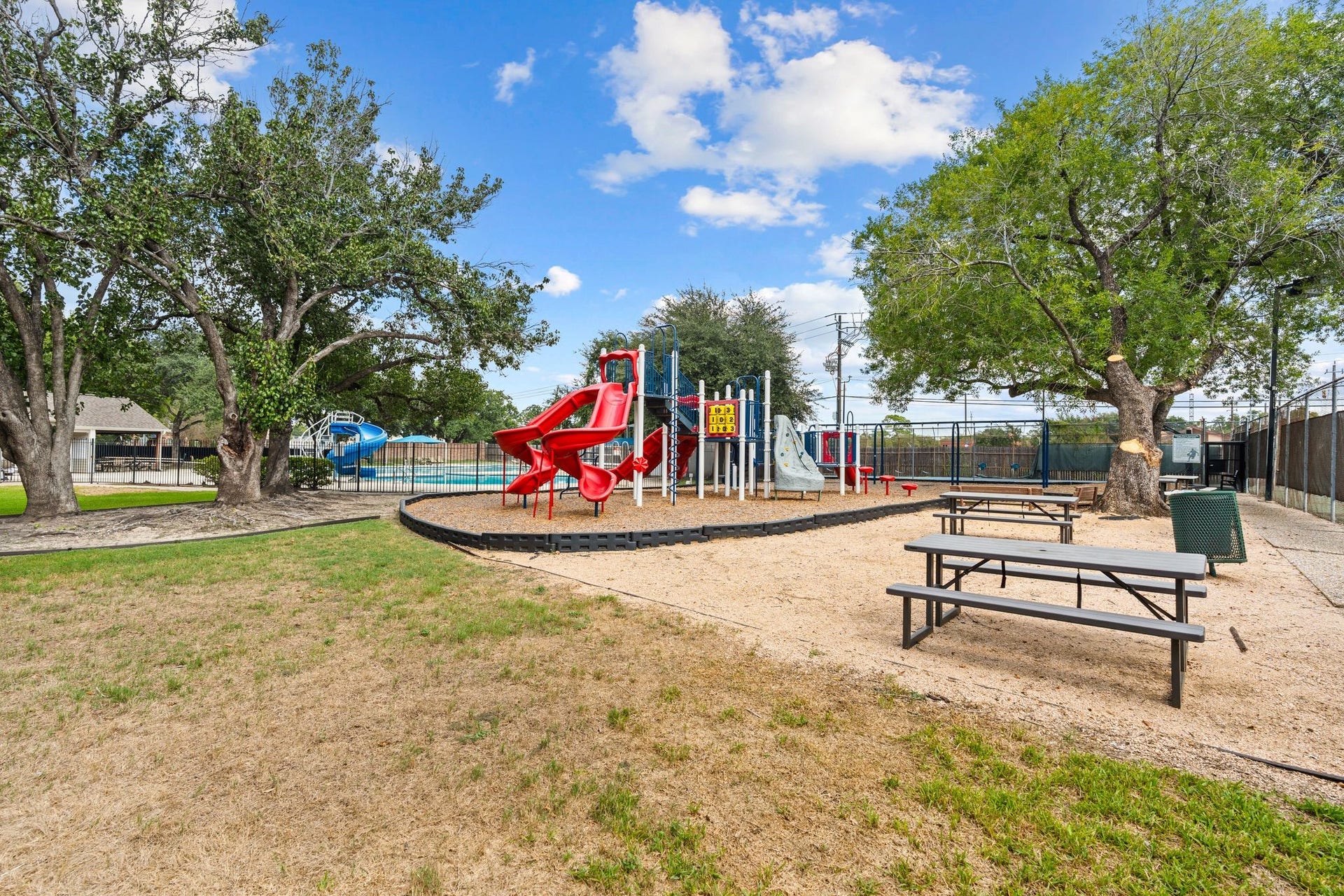 11519 Lakeside Place Drive, Houston, TX 77077 Enjoy family-friendly amenities with a vibrant playground, picnic tables, and lush trees, perfect for outdoor gatherings and play.