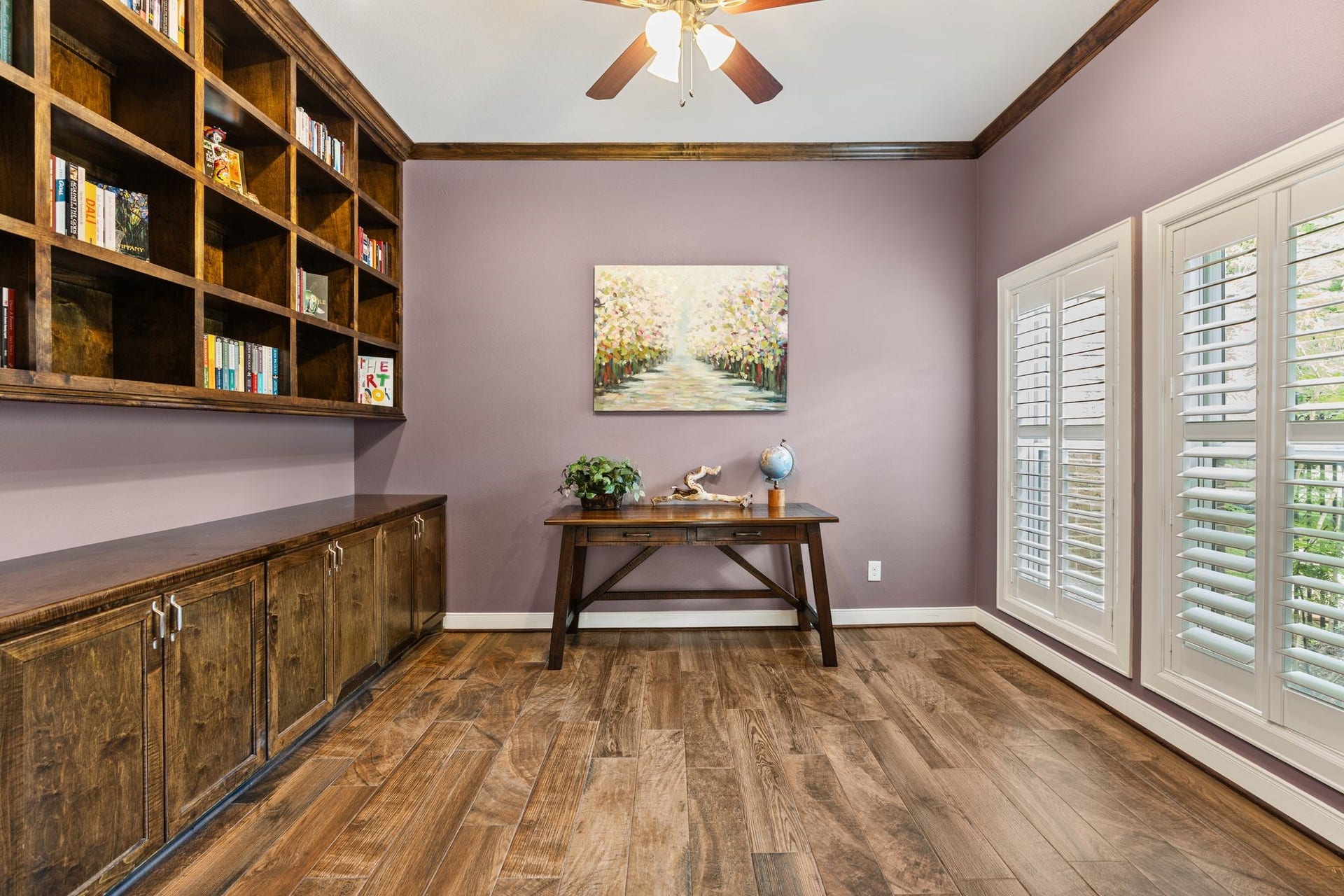 11519 Lakeside Place Drive, Houston, TX 77077 Private study with elegant wood flooring, custom built-in bookshelves, and abundant natural light from large windows with plantation shutters.