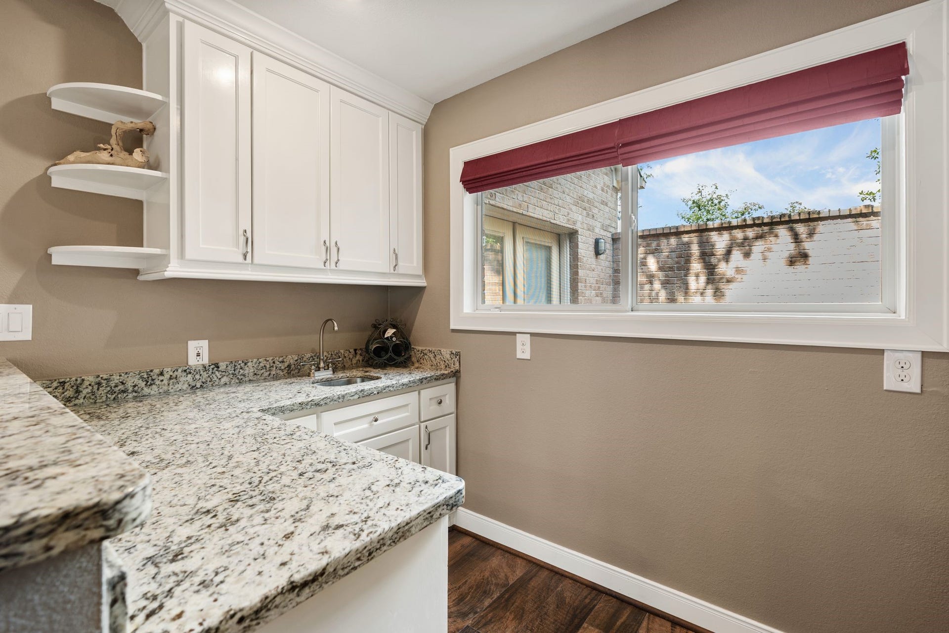 11519 Lakeside Place Drive, Houston, TX 77077 Kitchenette with granite countertops, cabinetry for storage, and a large window providing natural light and a pleasant view.