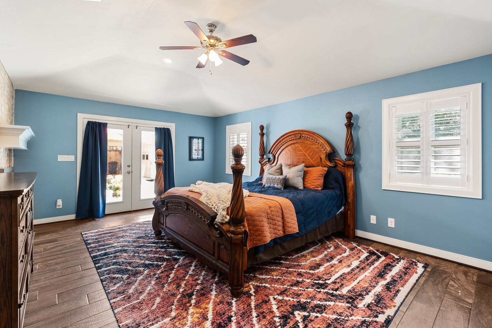 11519 Lakeside Place Drive, Houston, TX 77077 Spacious bedroom featuring elegant hardwood floors and natural light streams through French doors.