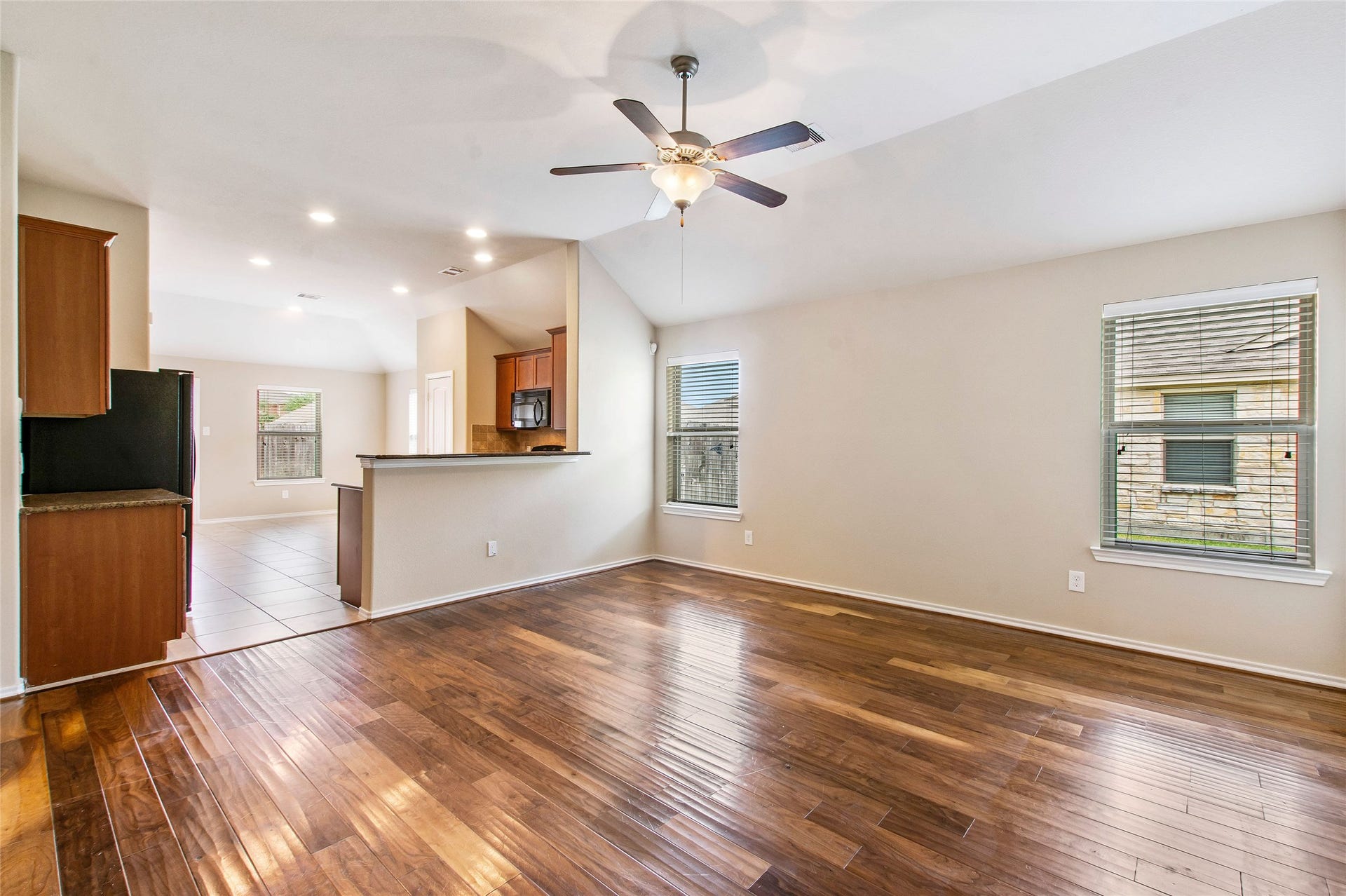 8746 Sunny Gallop Drive, Tomball, TX 77375 This family room space is open to the kitchen and features high ceilings, beautiful hardwoods, ceiling fan, lots of natural light and plenty of room for your furnishings.
