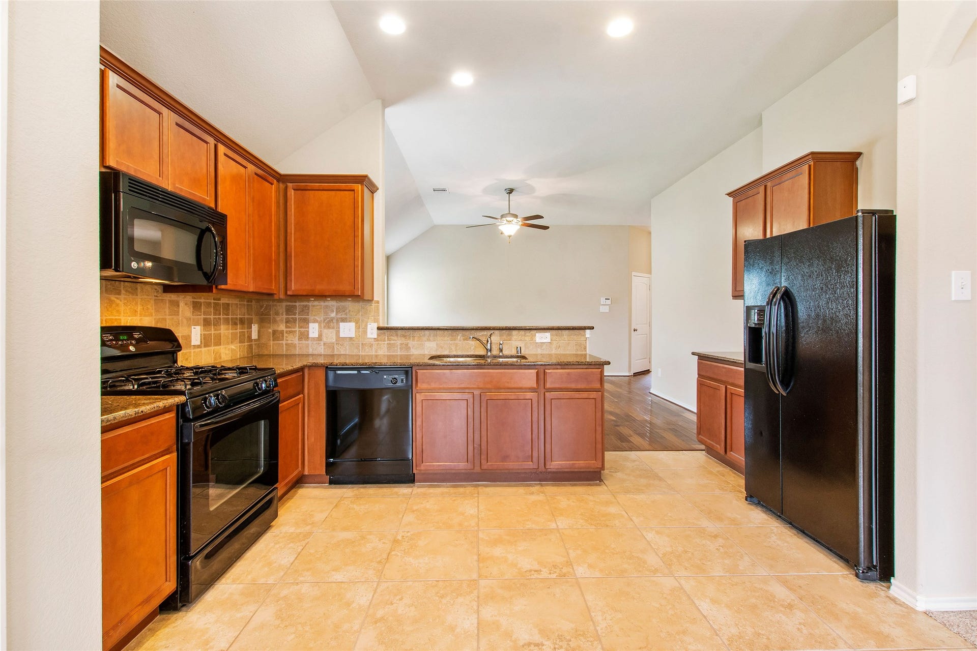 8746 Sunny Gallop Drive, Tomball, TX 77375 This spacious kitchen is well appointed with upgraded tile, backsplash, granite countertops, a nice size pantry. All appliances are included, even the refrigerator!