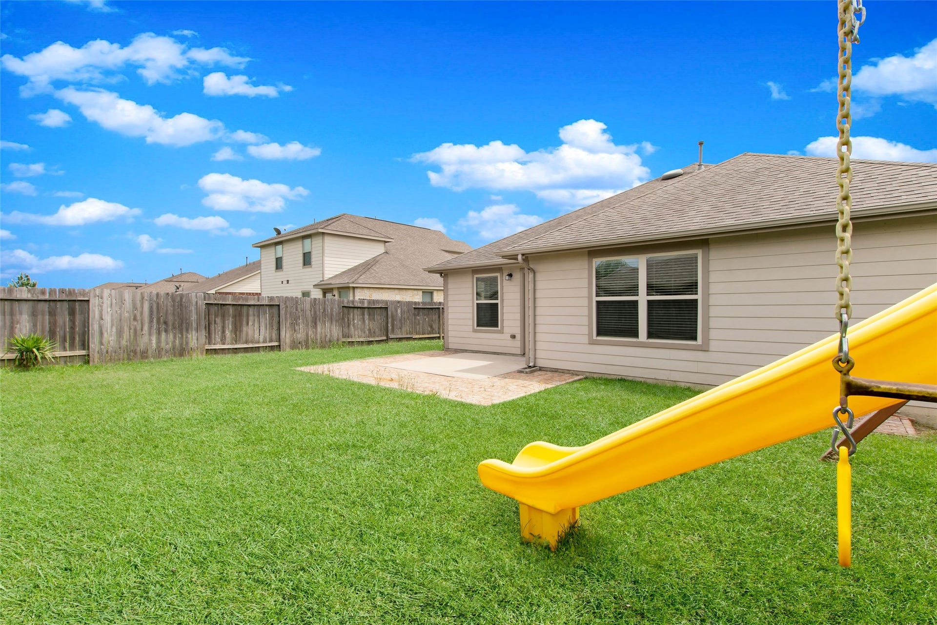 8746 Sunny Gallop Drive, Tomball, TX 77375 The backyard offers a nicely extended patio and plenty of yard to enjoy. Your kids will love this playset.