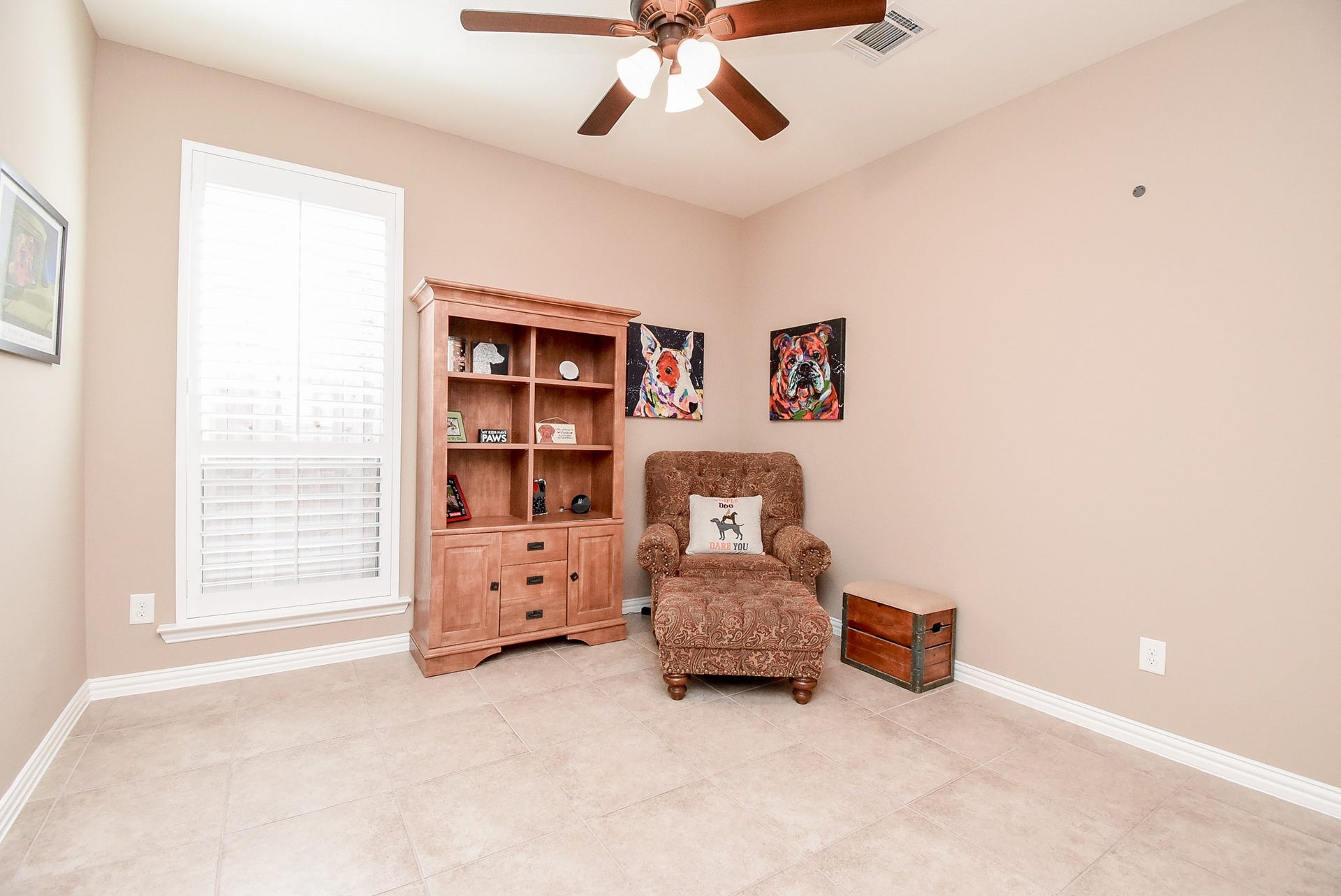 Second bedroom down with closet, ceiling fan and window shutters.