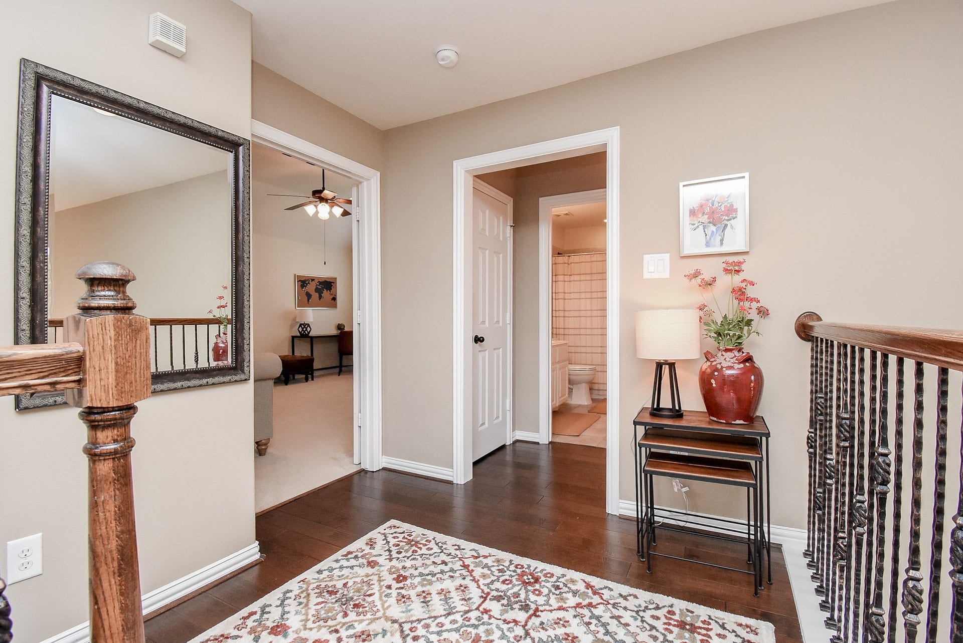 Top of landing looking into secondary full bath and door leading into another large bedroom.  Game room and media room entrance to the left