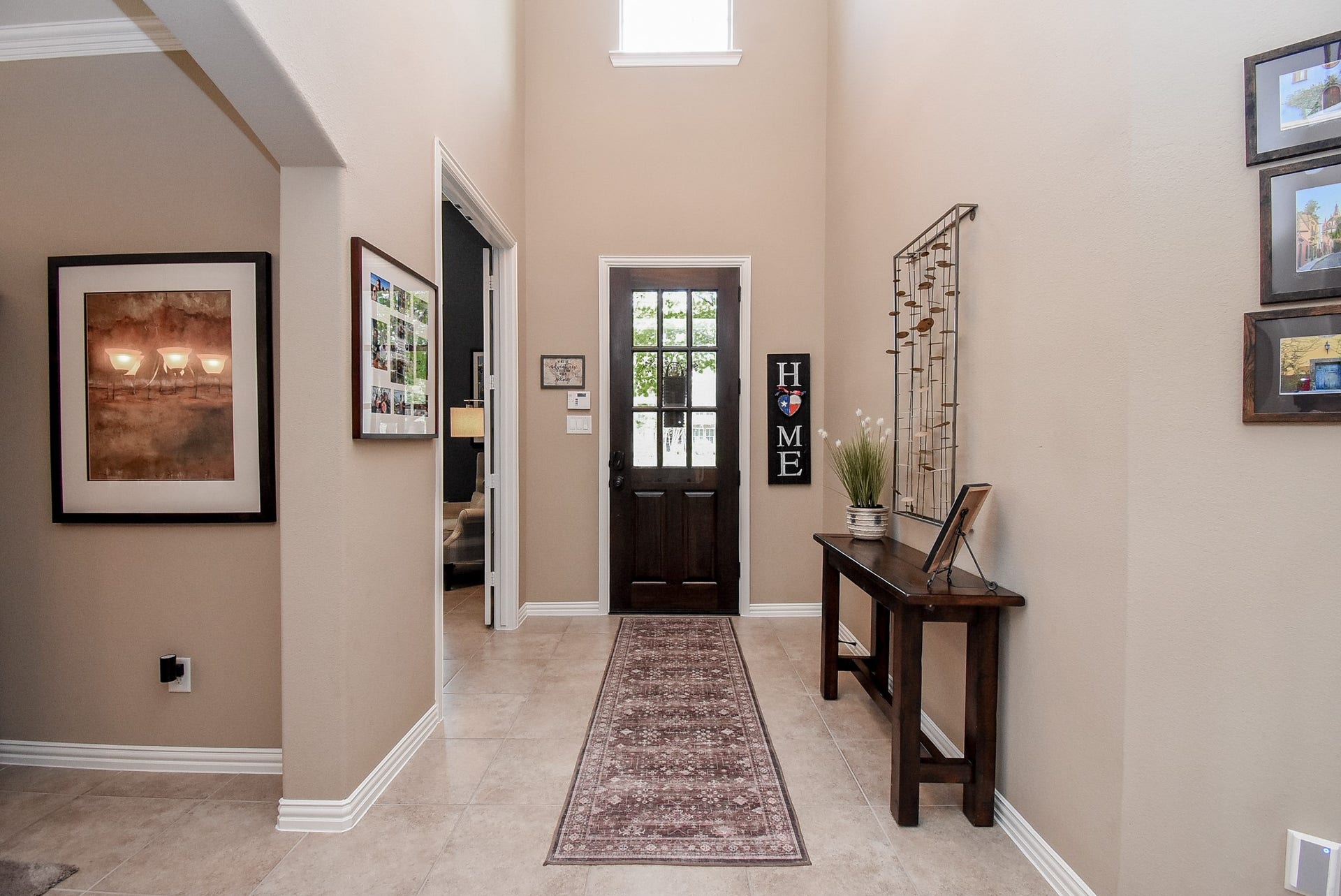 Looking back from the foyer, you can see the beautiful wood and glass stained door with plenty of natural light.