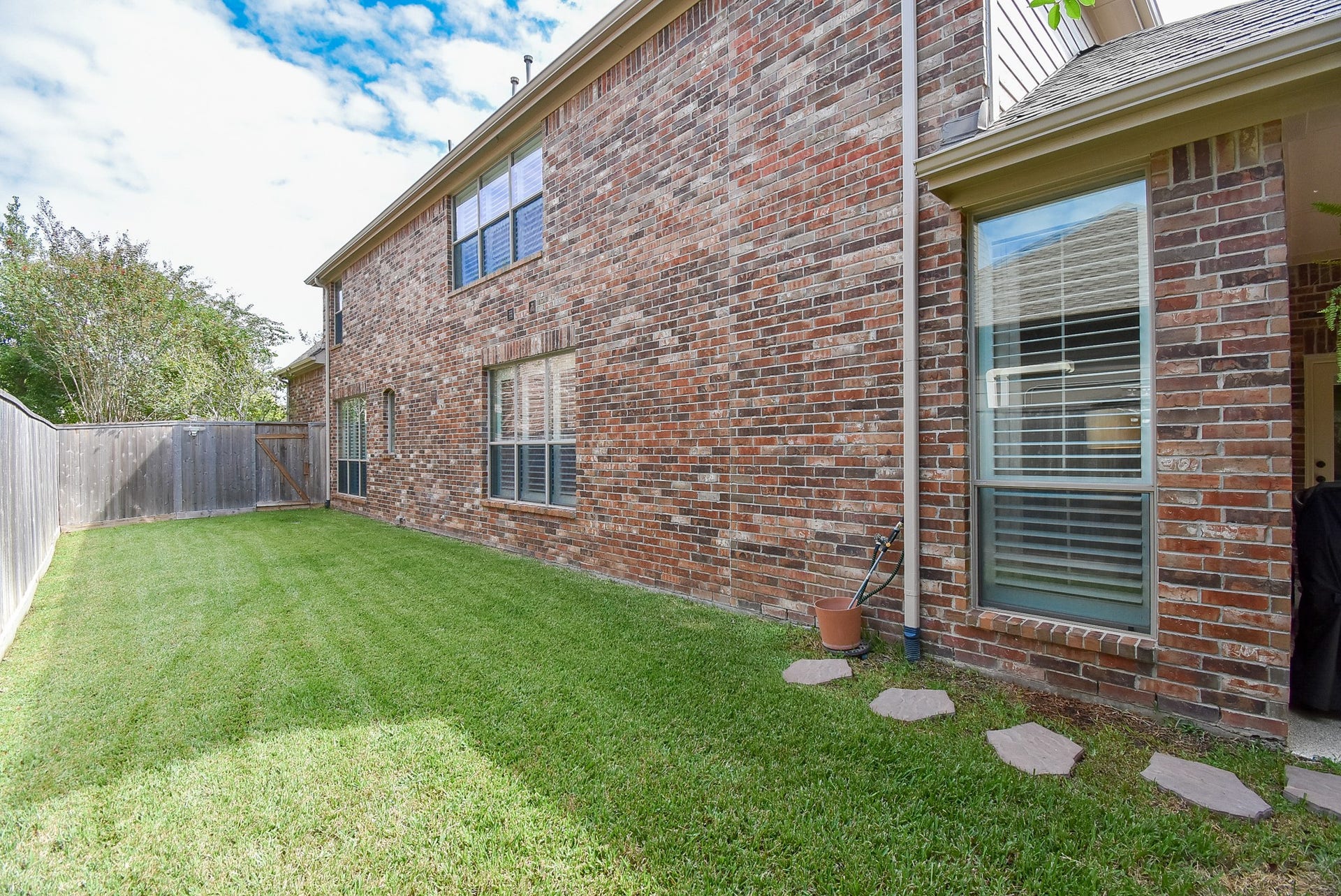 Large side yard has plenty of grass and space for pets/children or whatever you feel the need for.