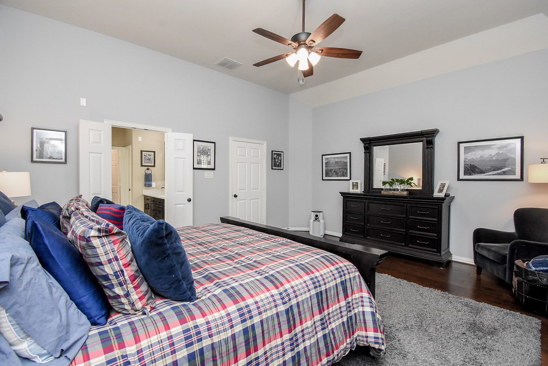 Another view of the Primary suite with high ceiling. Double doors lead into the primary bath.