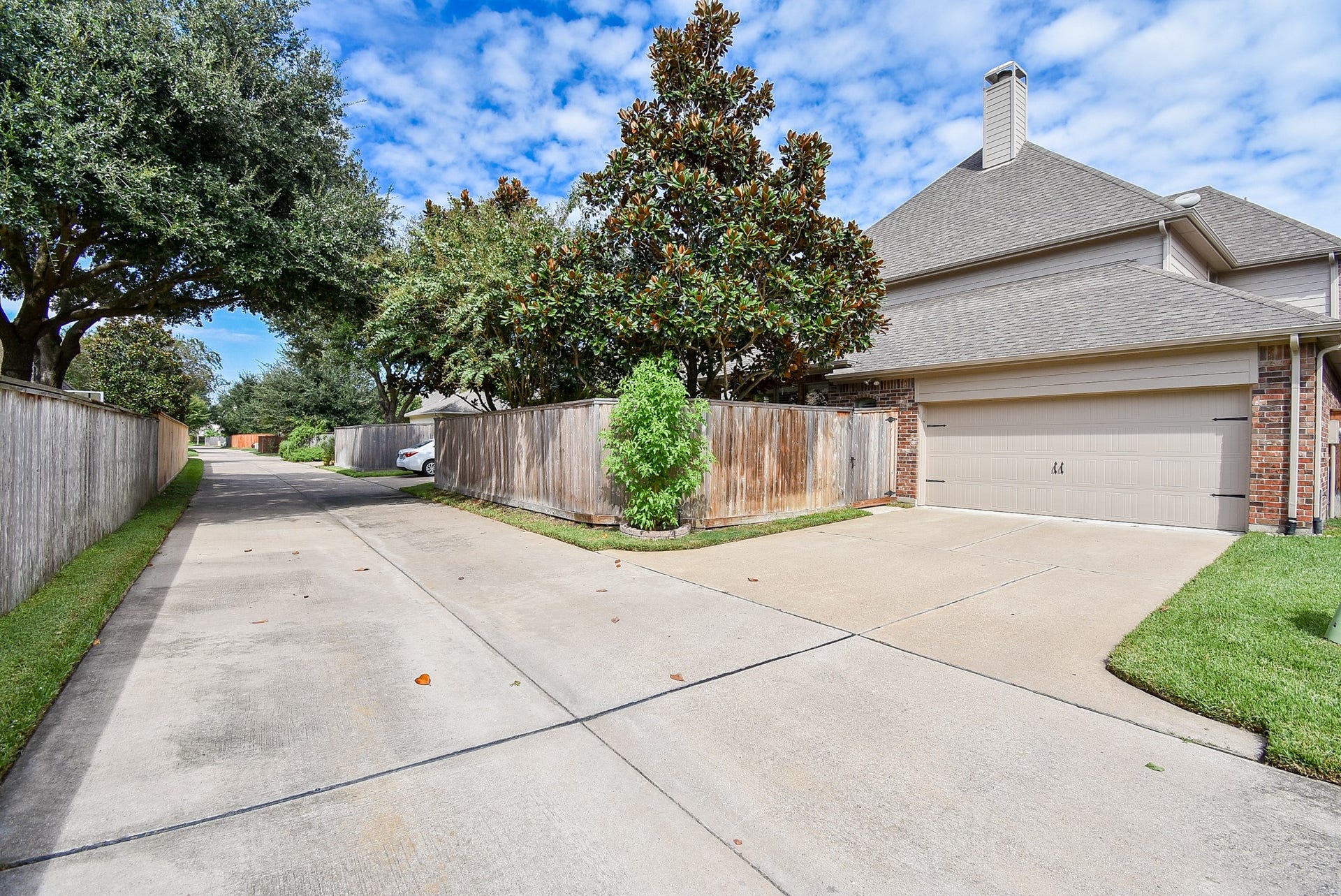Now this is awesome! A back alley/private road leads to your double car garage and back patio. This only adds to the uniqueness of this niche neighborhood in the heart of Cinco Ranch!