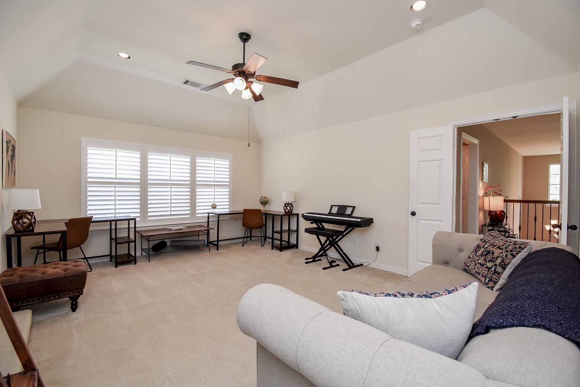 Another view of the large game room with double doors leading into the second floor landing and media room.