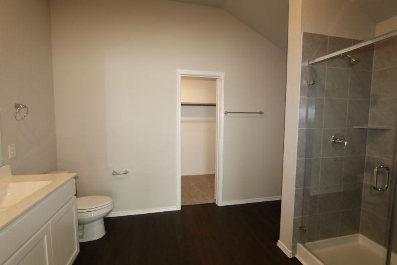 Primary bath with walk in shower and large walk-in closet