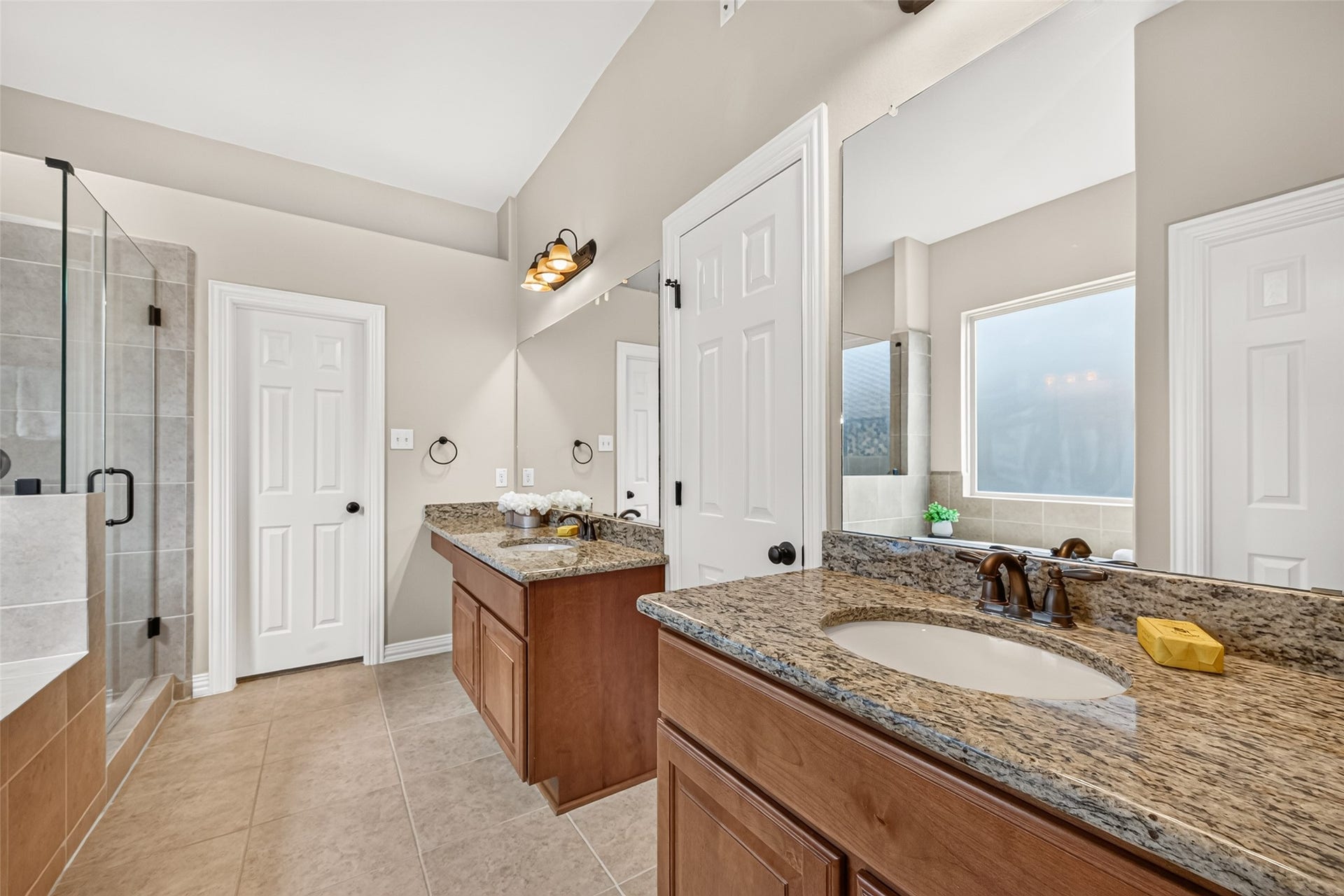 Updated primary bathroom with separate his and hers walk-in closets