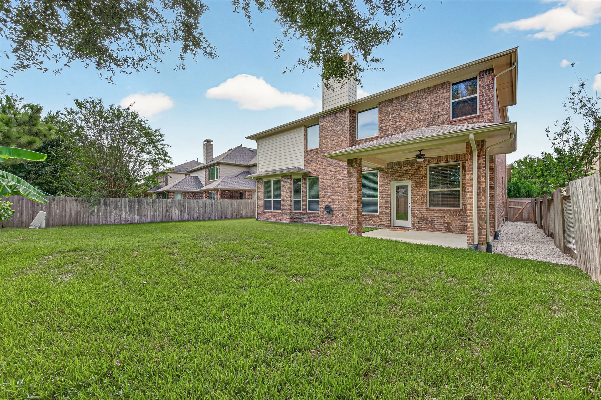 Spacious brick-fenced backyard with room to create your own pool