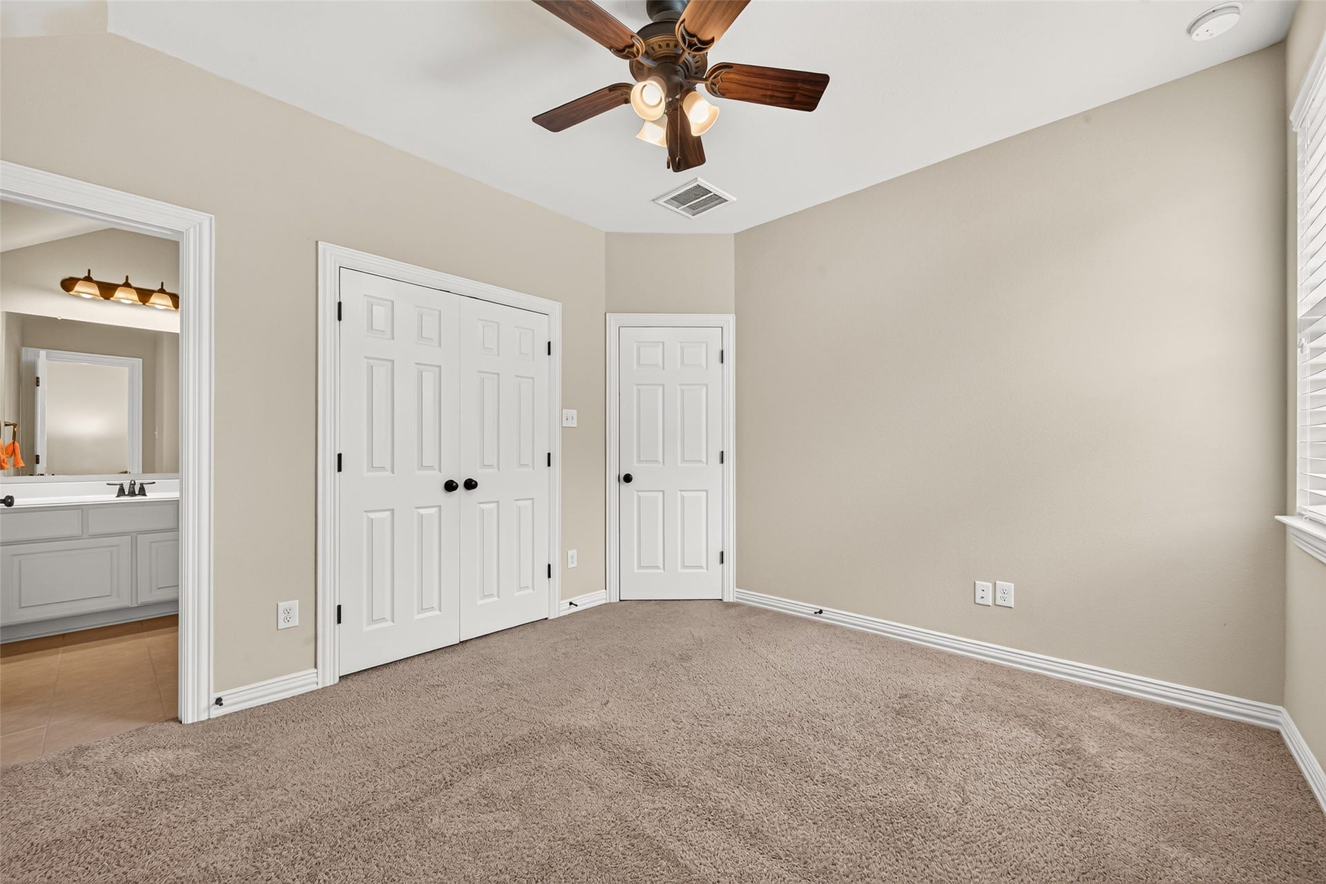 Bedroom with closet and bathroom entrance
