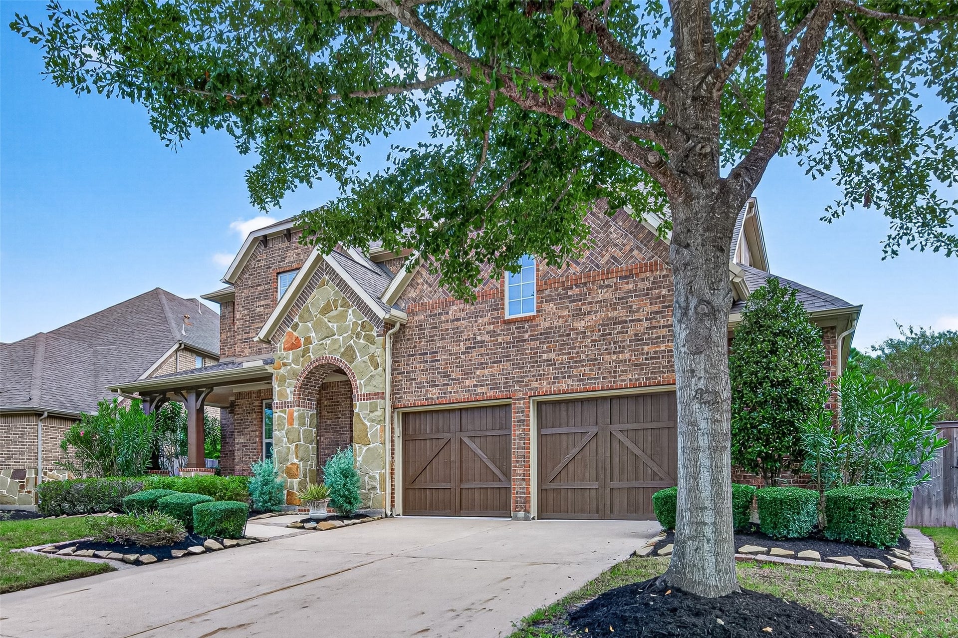 Driveway and attached garage with storage space