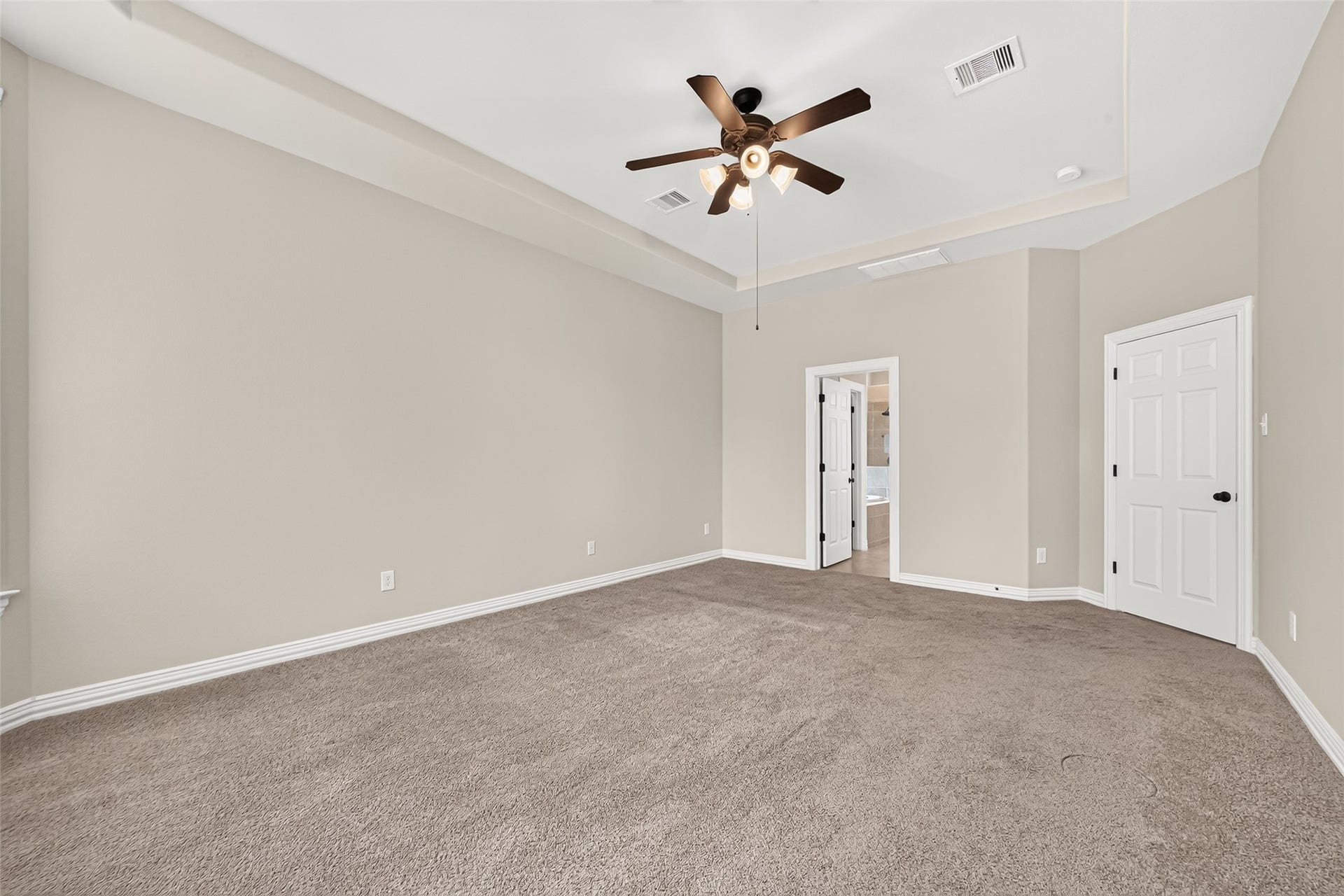 Primary bedroom with tray ceiling