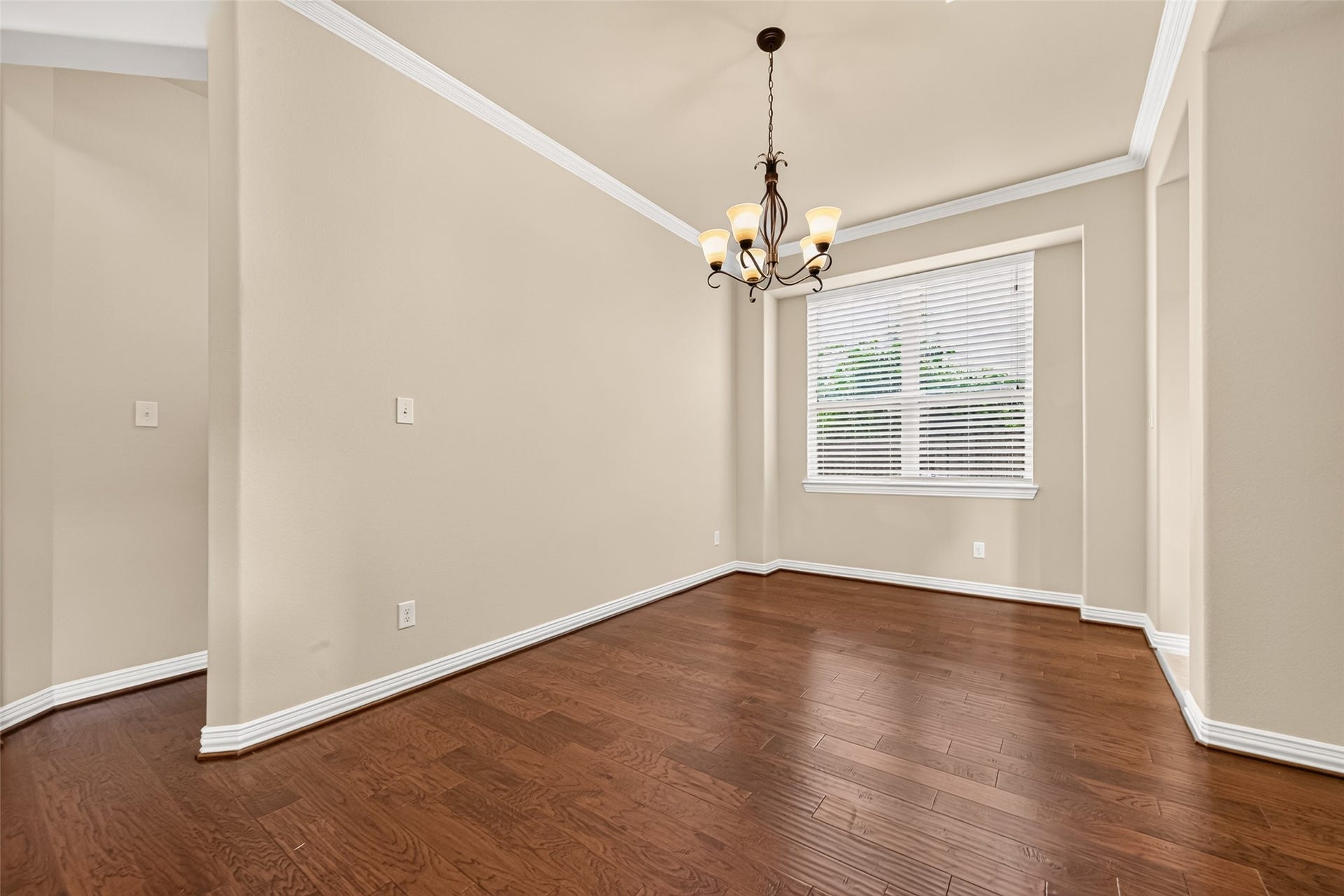 Formal dining room with chandelier, natural light and engineered wood floors