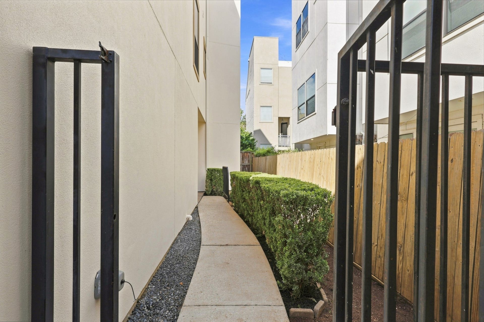 The private gated entry leading directly into the side patio, creating a defined outdoor space with added privacy and a convenient entrance to the home.