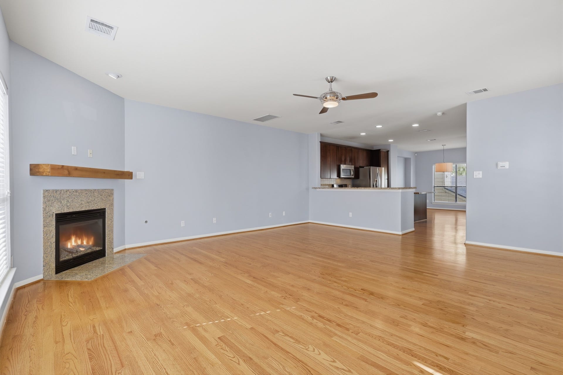 Spacious living area anchored by a fireplace, with an open layout ideal for everyday living and entertaining.
