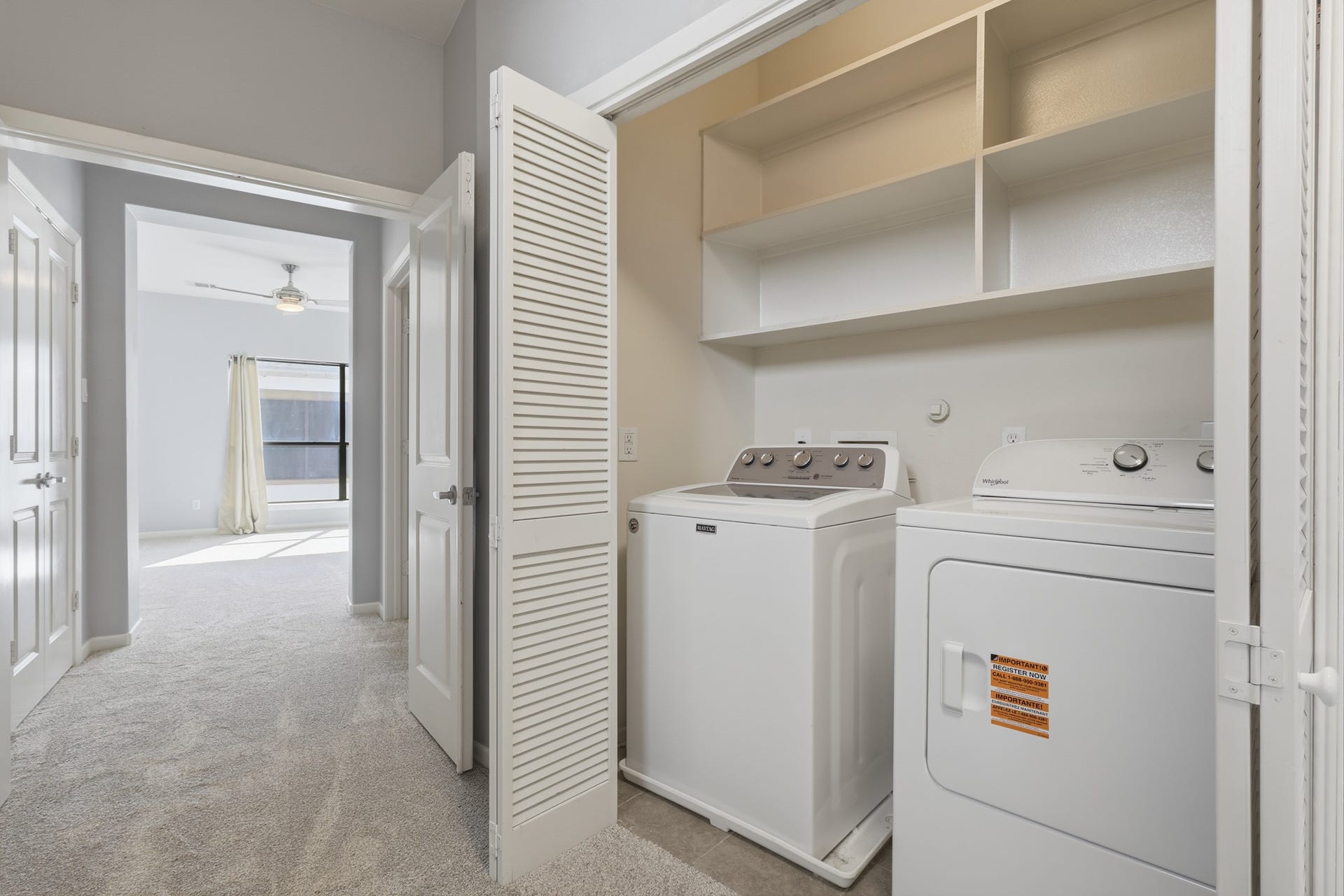 Convenient utility area with built-in shelving for additional storage and organization.
