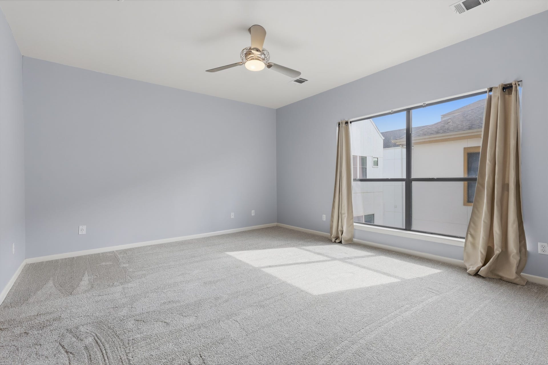 Primary bedroom featuring large windows that bring in abundant natural light