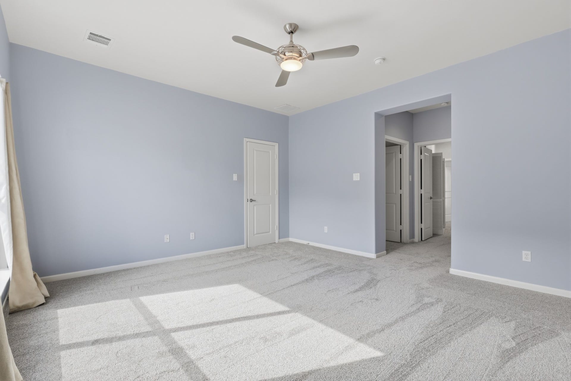 Spacious primary bedroom with plenty of room for additional seating or furnishings