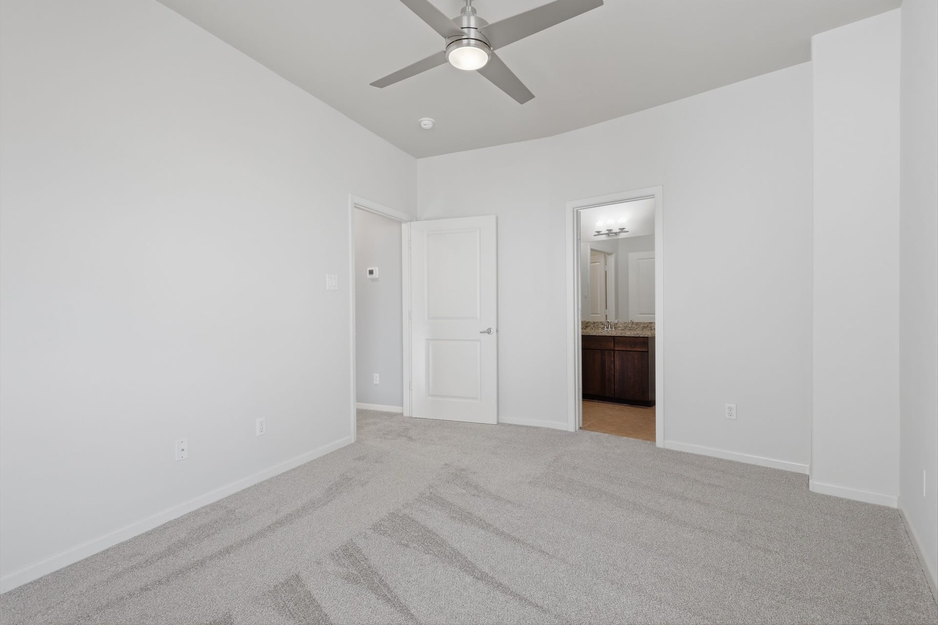 Additional view of the third bedroom highlighting its size and versatile layout.