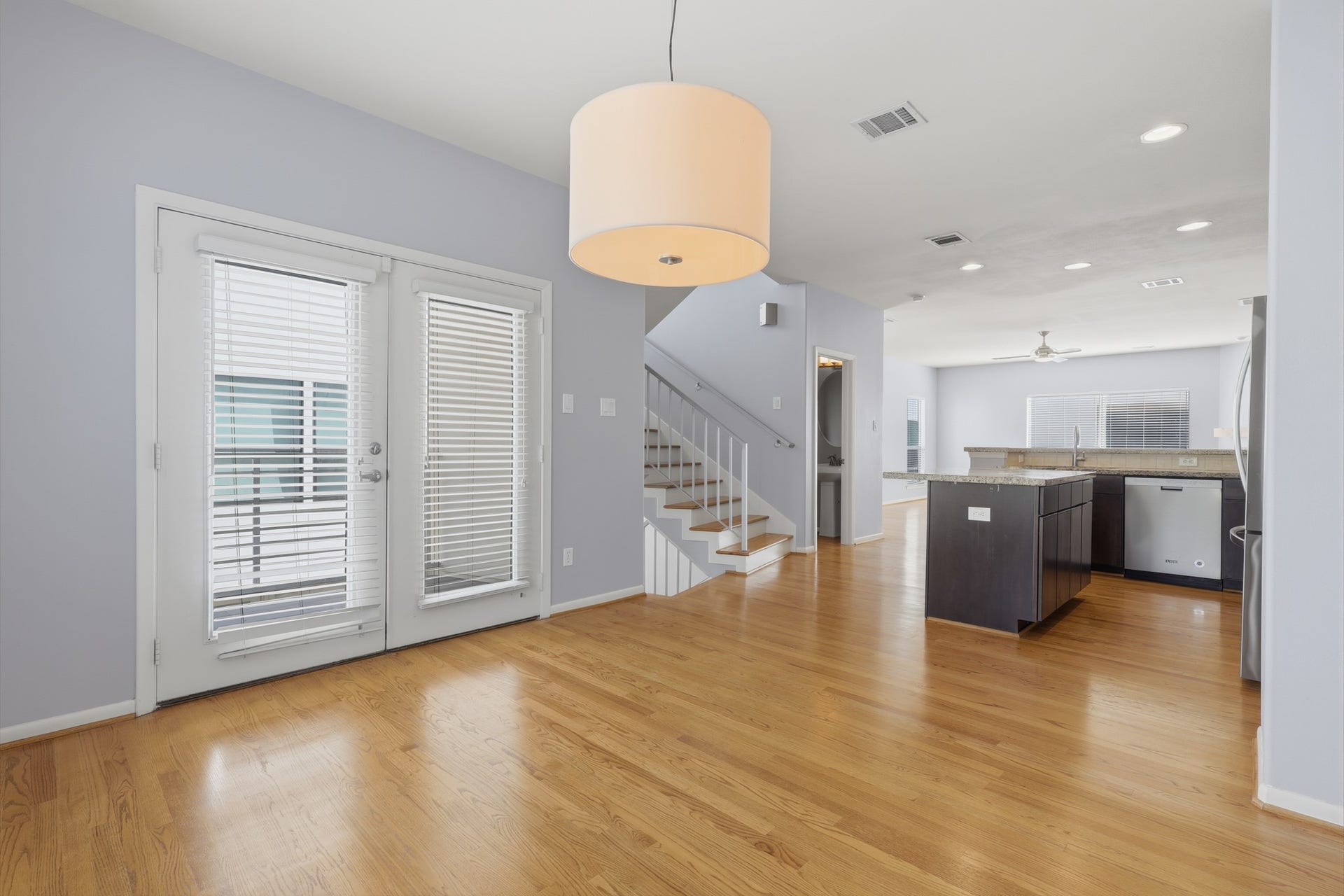 Dining area with double doors providing direct access to the private balcony, bringing in natural light and extending the living space outdoors.