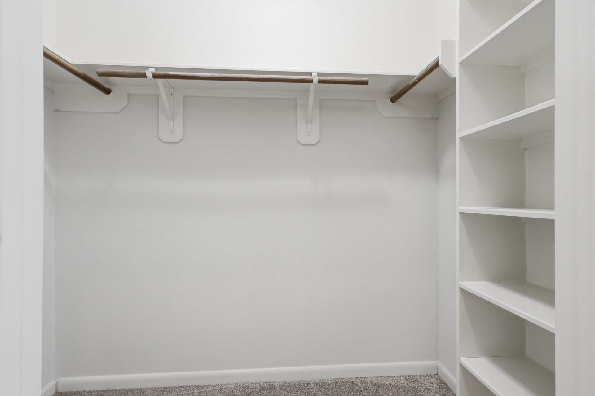 Generous closet space with built-in shelving for convenient storage and organization.