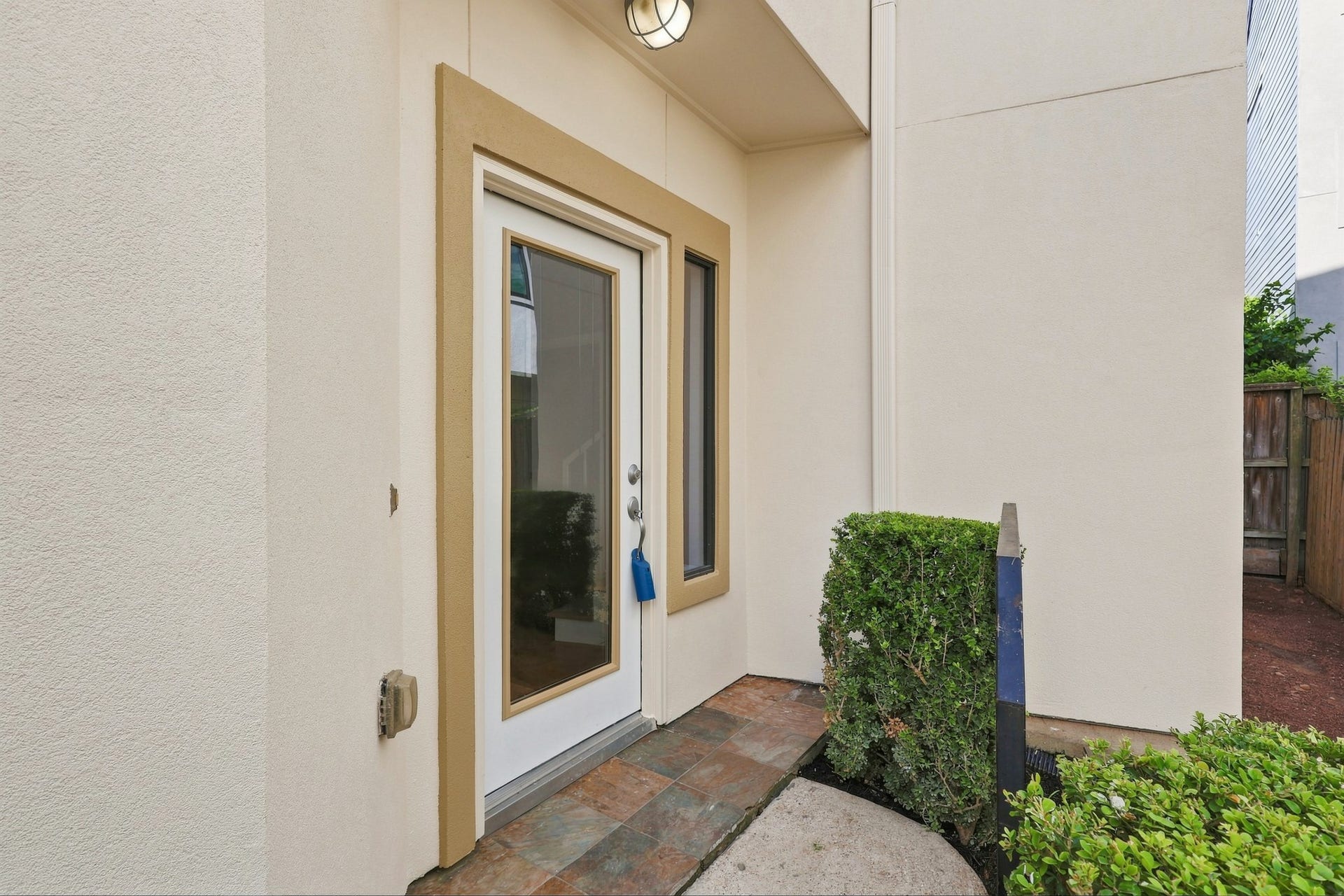 Front entry with direct views toward the private side patio, highlighting the home's unique corner-lot outdoor space.