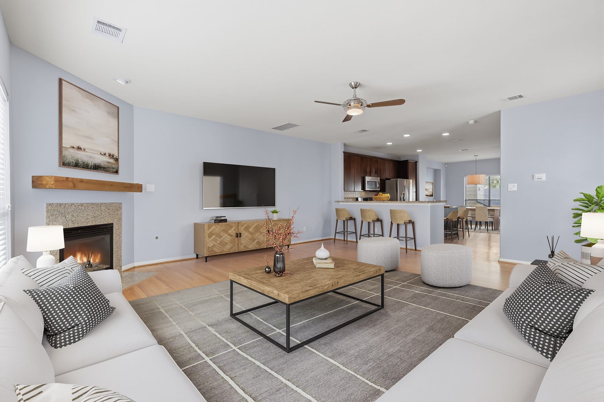 Virtually staged living area showcasing the spacious open-concept layout, fireplace, and abundant natural light.