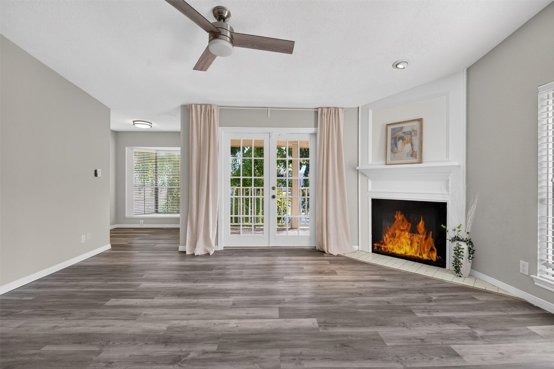 2220 Bering Drive, #12, Houston, TX 77057 Unstaged primary suite showcasing its spacious layout, fireplace, and French doors to the covered balcony.