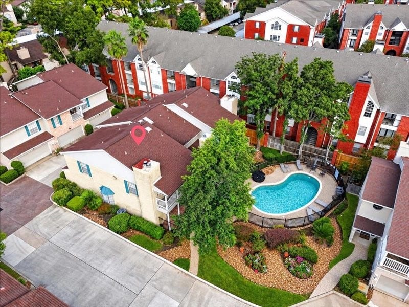 2220 Bering Drive, #12, Houston, TX 77057 Aerial view of Bering Oaks, showing the homes location near the community pool, mature trees, and landscaped grounds. Location marker is approximate.