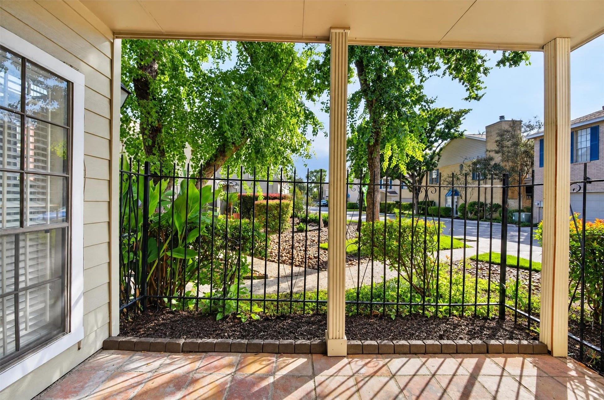 2220 Bering Drive, #12, Houston, TX 77057 Covered, fenced patio overlooking landscaped grounds and mature trees.