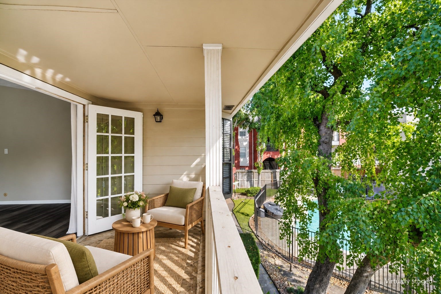 2220 Bering Drive, #12, Houston, TX 77057 Covered balcony off the primary suite, overlooking mature trees and the community poola relaxing retreat for morning coffee or unwinding outdoors. Virtually staged.