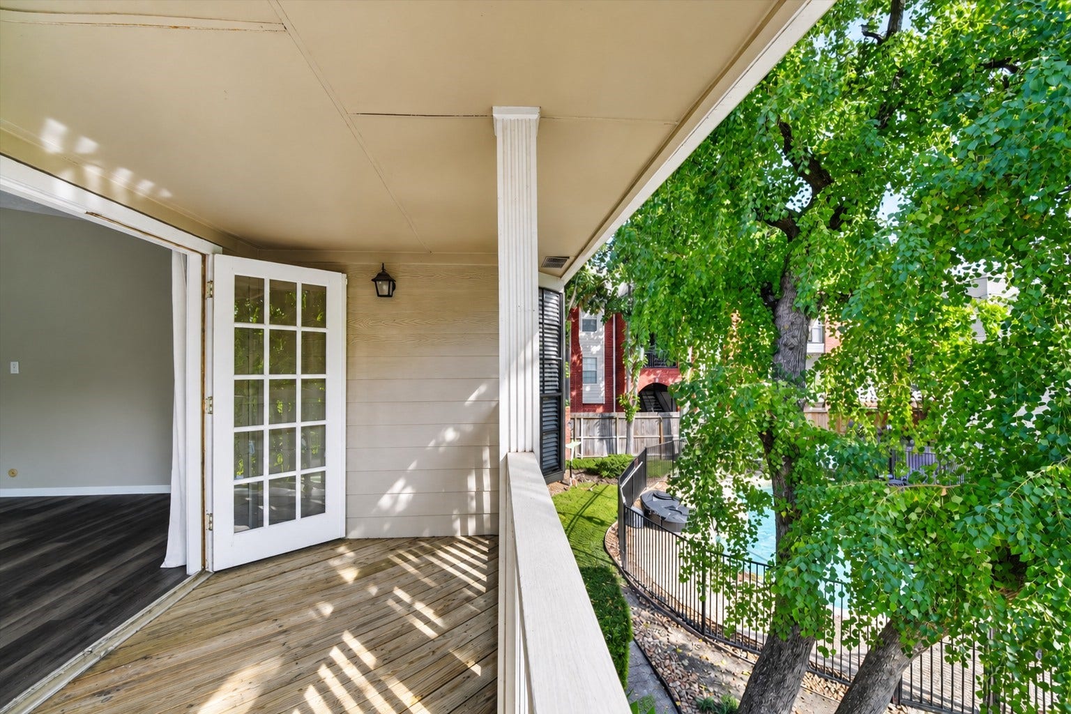 2220 Bering Drive, #12, Houston, TX 77057 Covered balcony off the primary suite, overlooking mature trees and the community poola relaxing retreat for morning coffee or unwinding outdoors.