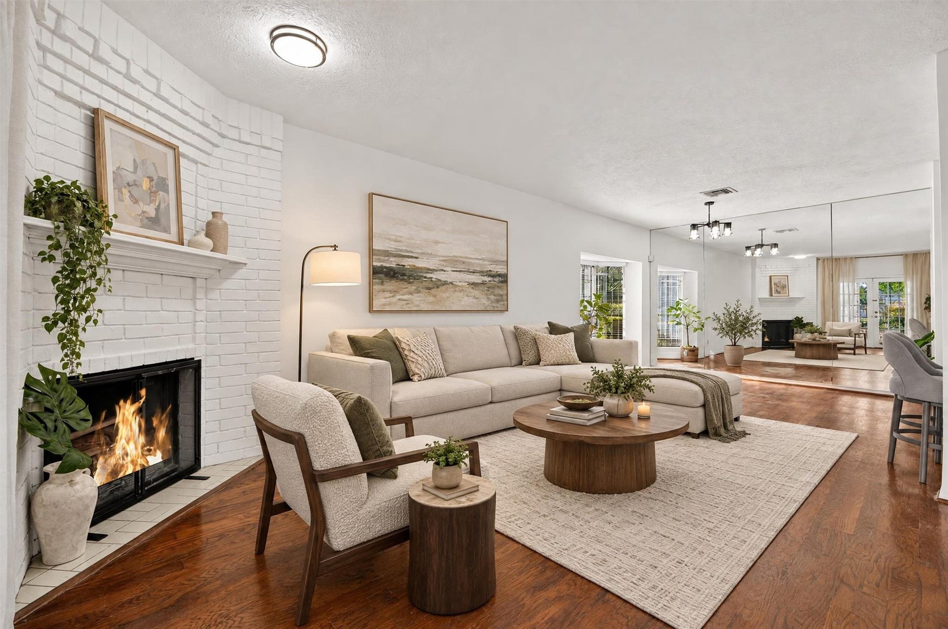 2220 Bering Drive, #12, Houston, TX 77057 Bright living room with a fireplace and an open layout connecting to the dining area. Virtually staged.