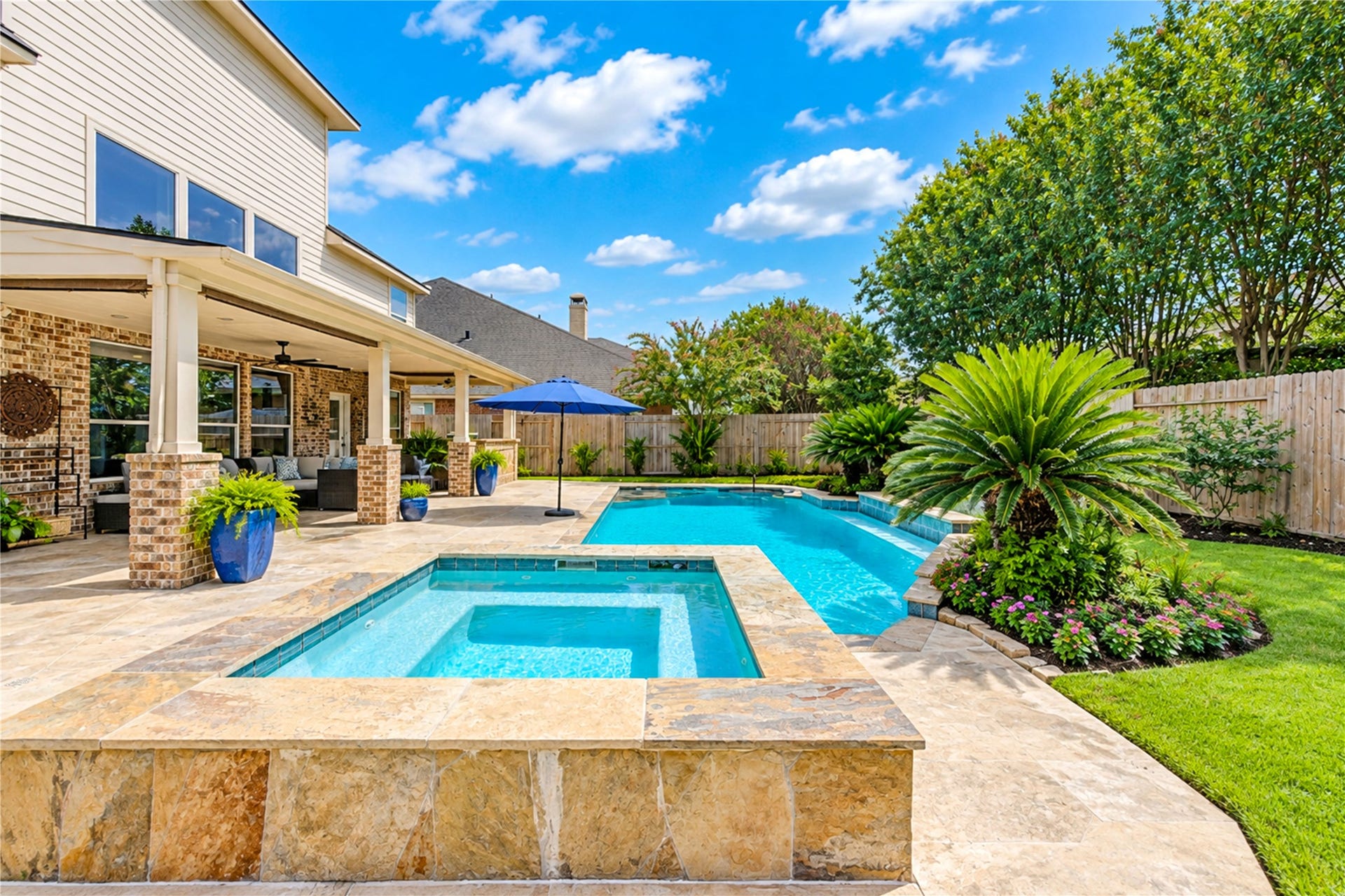 28019 Longspur Drive, Katy, TX 77494 Tile around the spa looking across the pool. Nice landscaping.