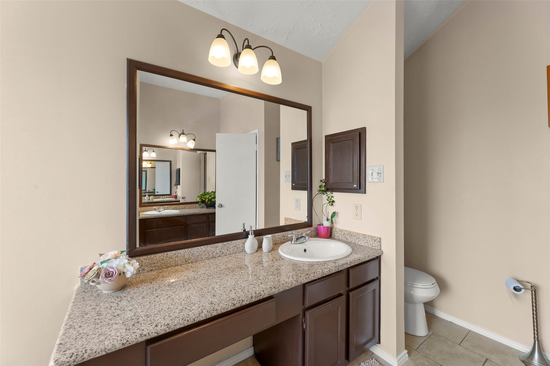 2033 Wildwood Ridge Drive, Missouri City, TX 77489 Modern bathroom space highlighted by a wide, expansive wall mirror, clean lines, and a bright atmosphere.