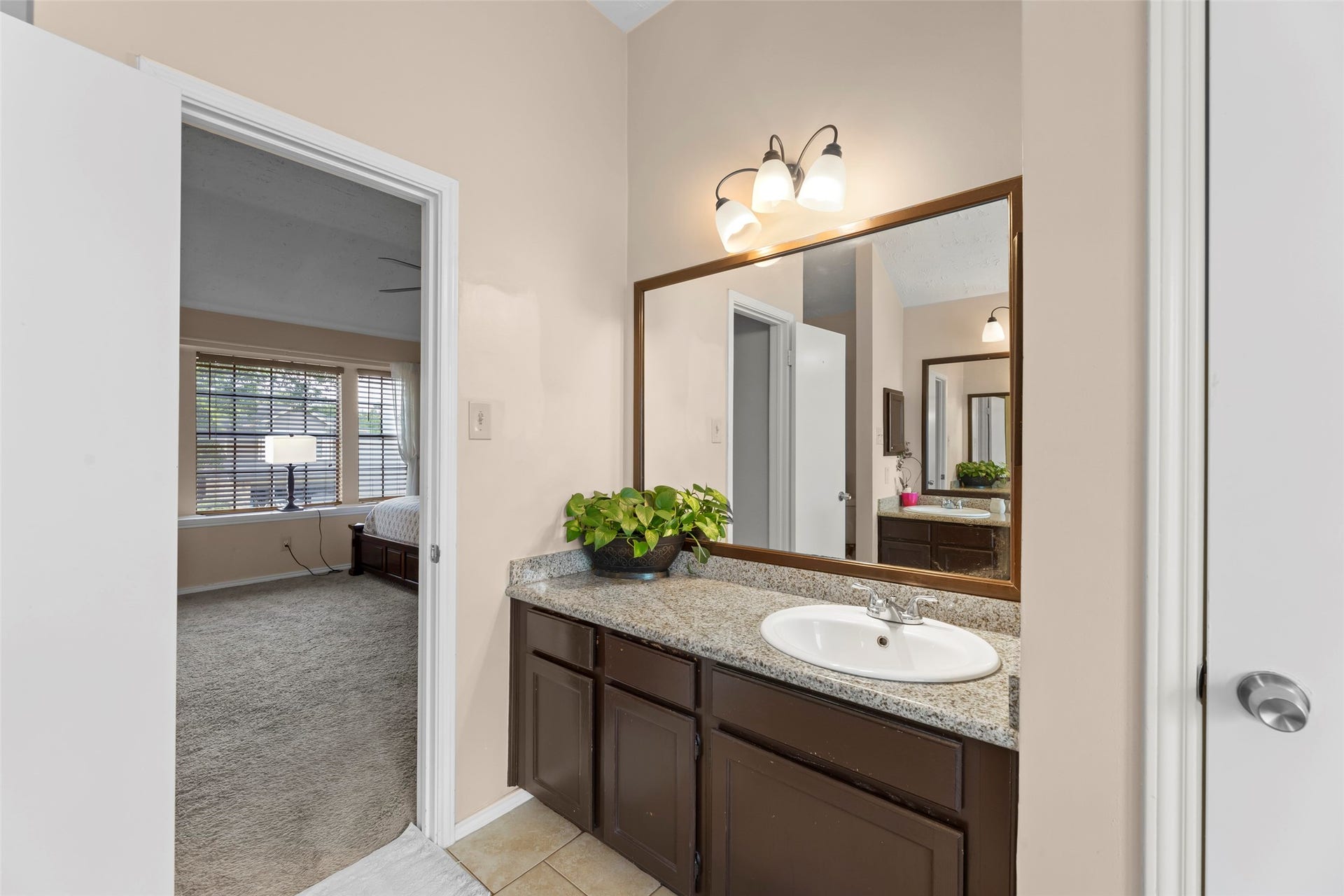 2033 Wildwood Ridge Drive, Missouri City, TX 77489 The bathroom features durable neutral floor tiling that complements the clean aesthetic of the space.