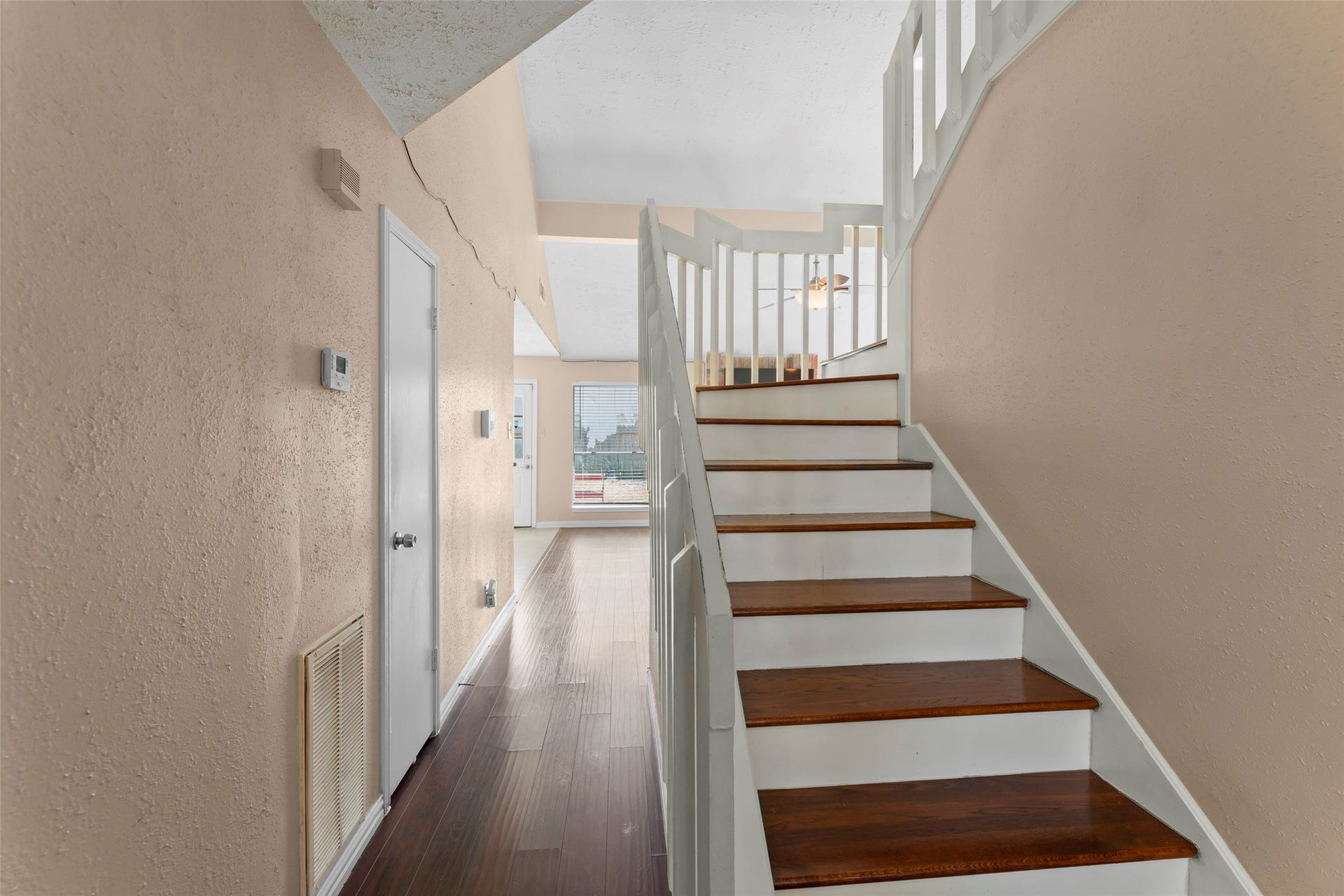 2033 Wildwood Ridge Drive, Missouri City, TX 77489 Elegant rich hardwood treads, classic white painted risers, and a traditional decorative railing overlooking the main living area.