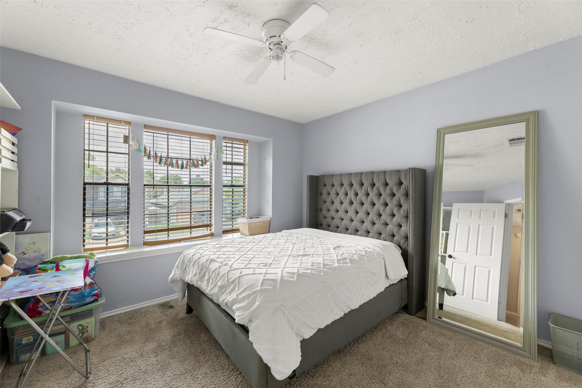 2033 Wildwood Ridge Drive, Missouri City, TX 77489 Inviting bedroom space highlighted by soft, versatile neutral wall tones that compliment the bright space and carpet flooring.
