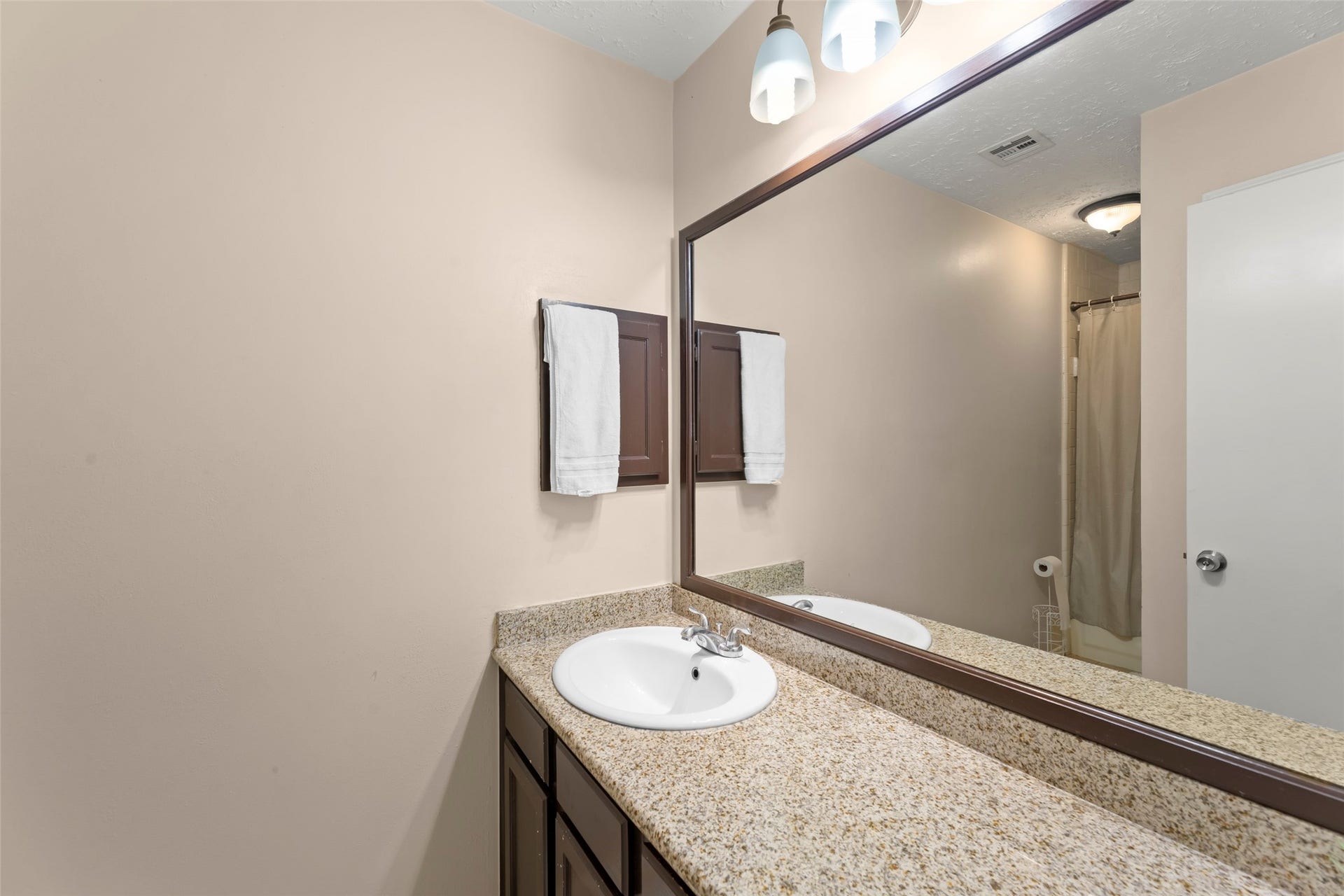 2033 Wildwood Ridge Drive, Missouri City, TX 77489 A vanity area complete with dual sinks, modern lighting fixtures, extensive cabinetry, and a wide framed mirror.