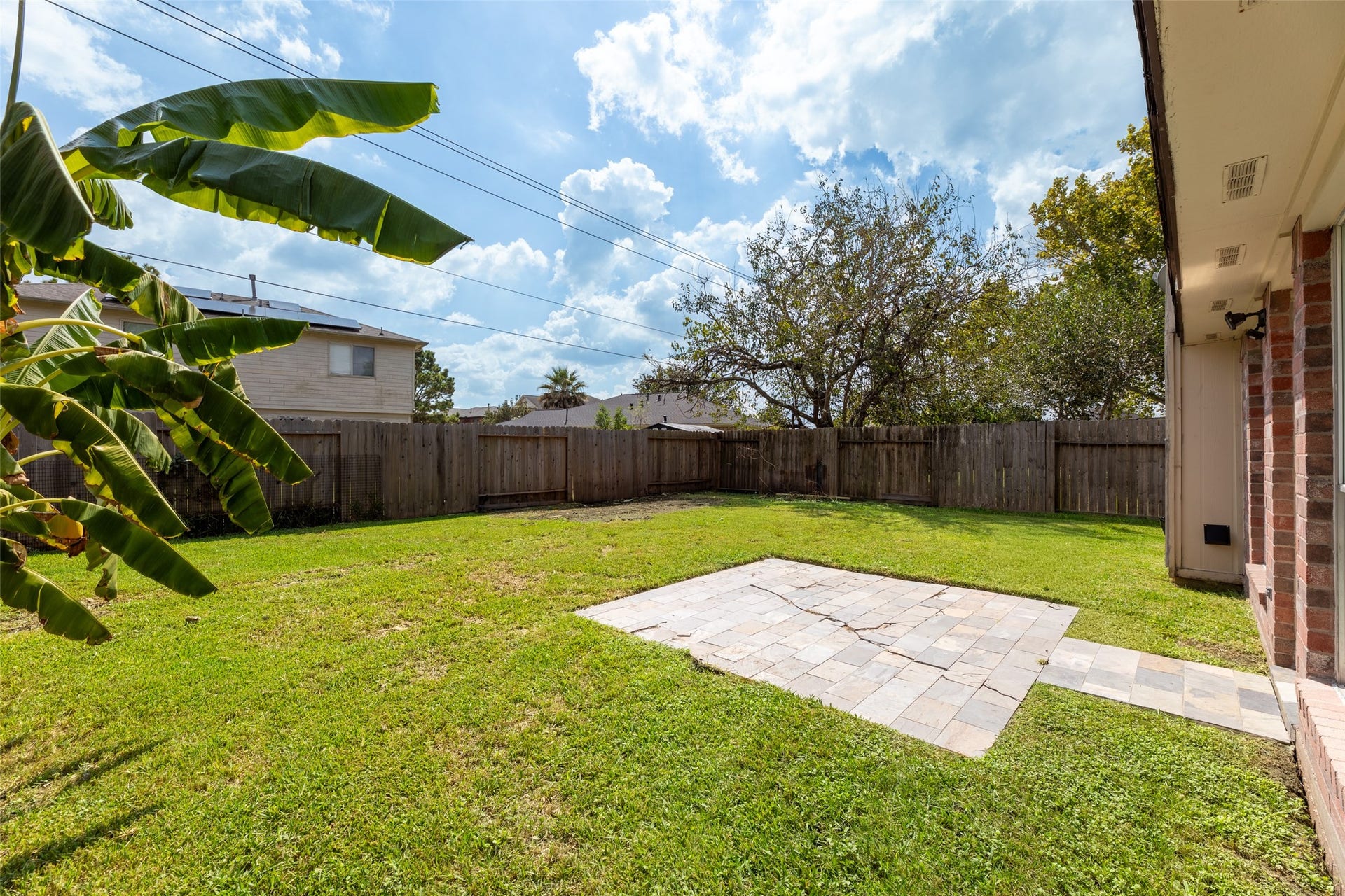 2033 Wildwood Ridge Drive, Missouri City, TX 77489 This outdoor space features a clean wooden fence that provides privacy and complements the natural surroundings.